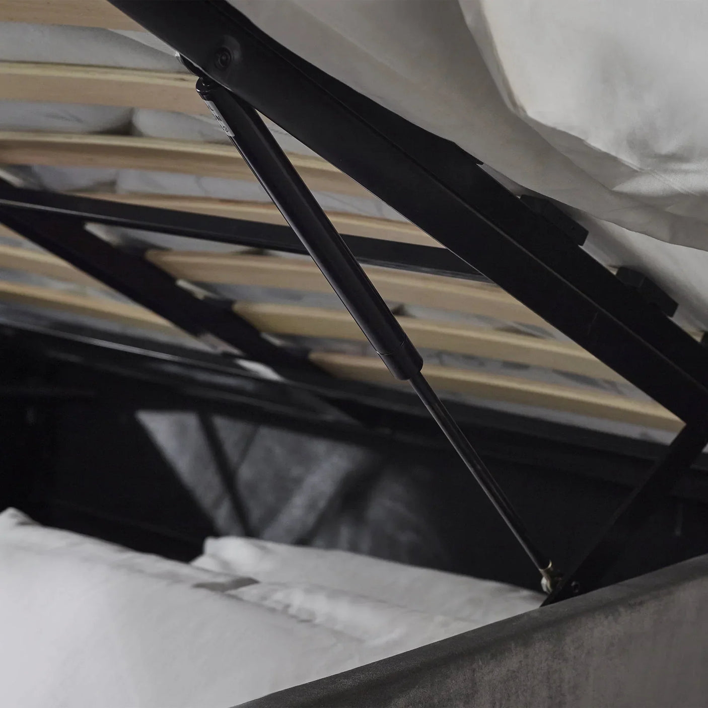 Lift-up storage bed gas lift mechanism and slatted base in close detail
