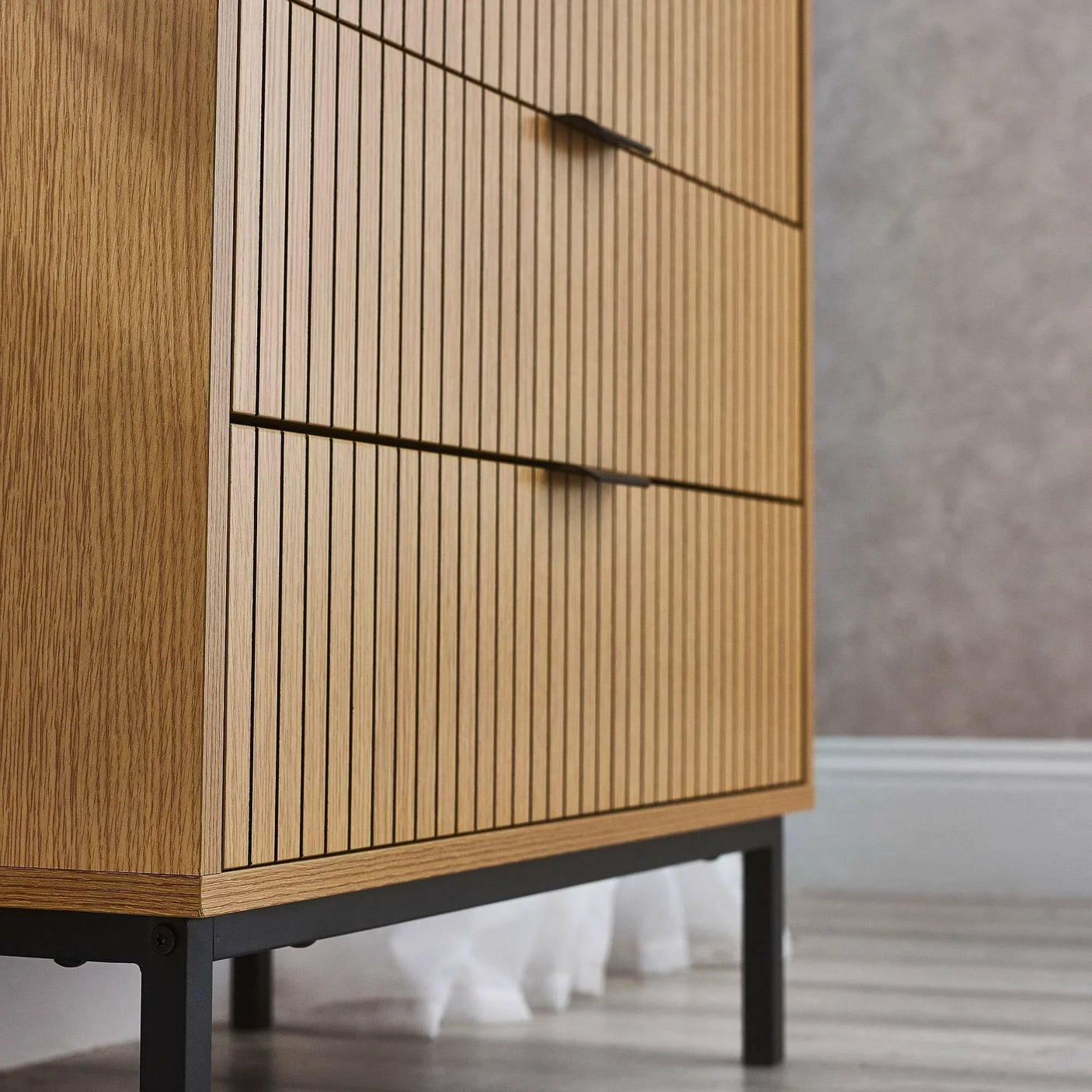 Oak wood chest of drawers with vertical slatted front and black metal legs