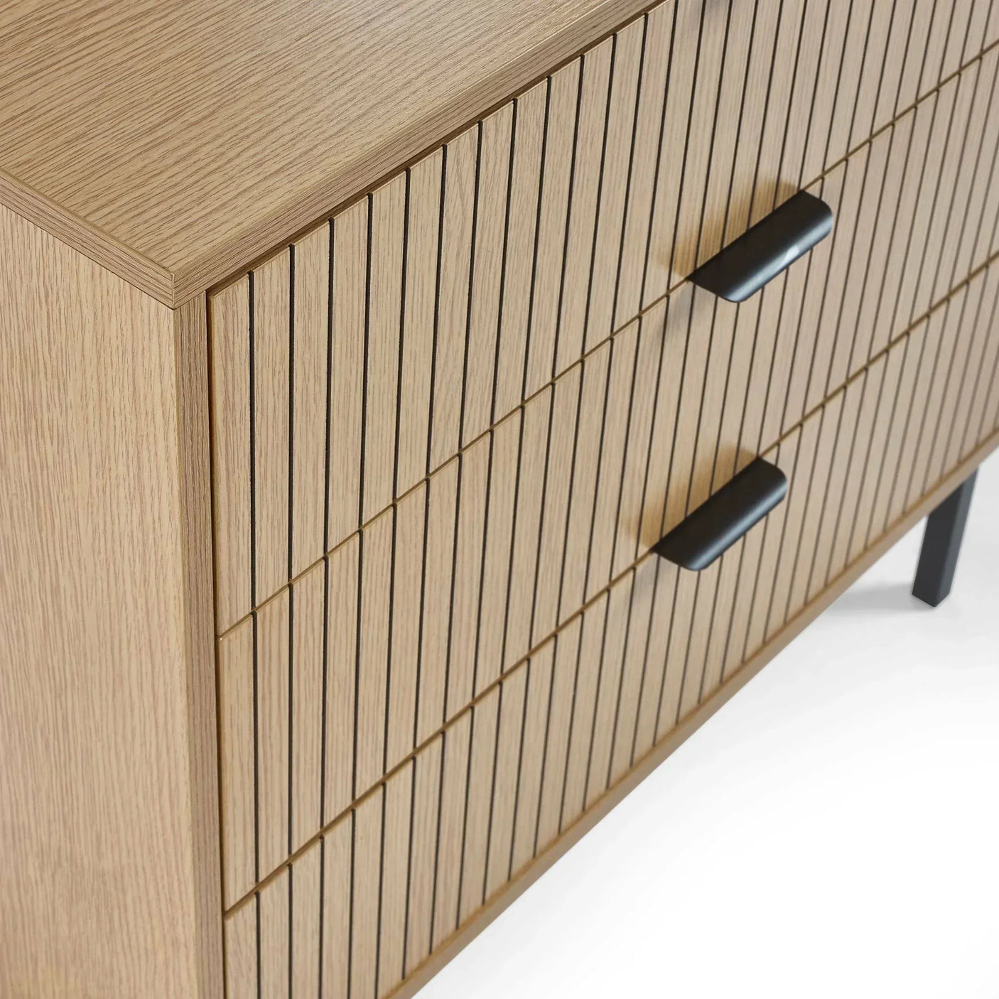 Modern wooden chest of drawers with vertical slatted front and black handles