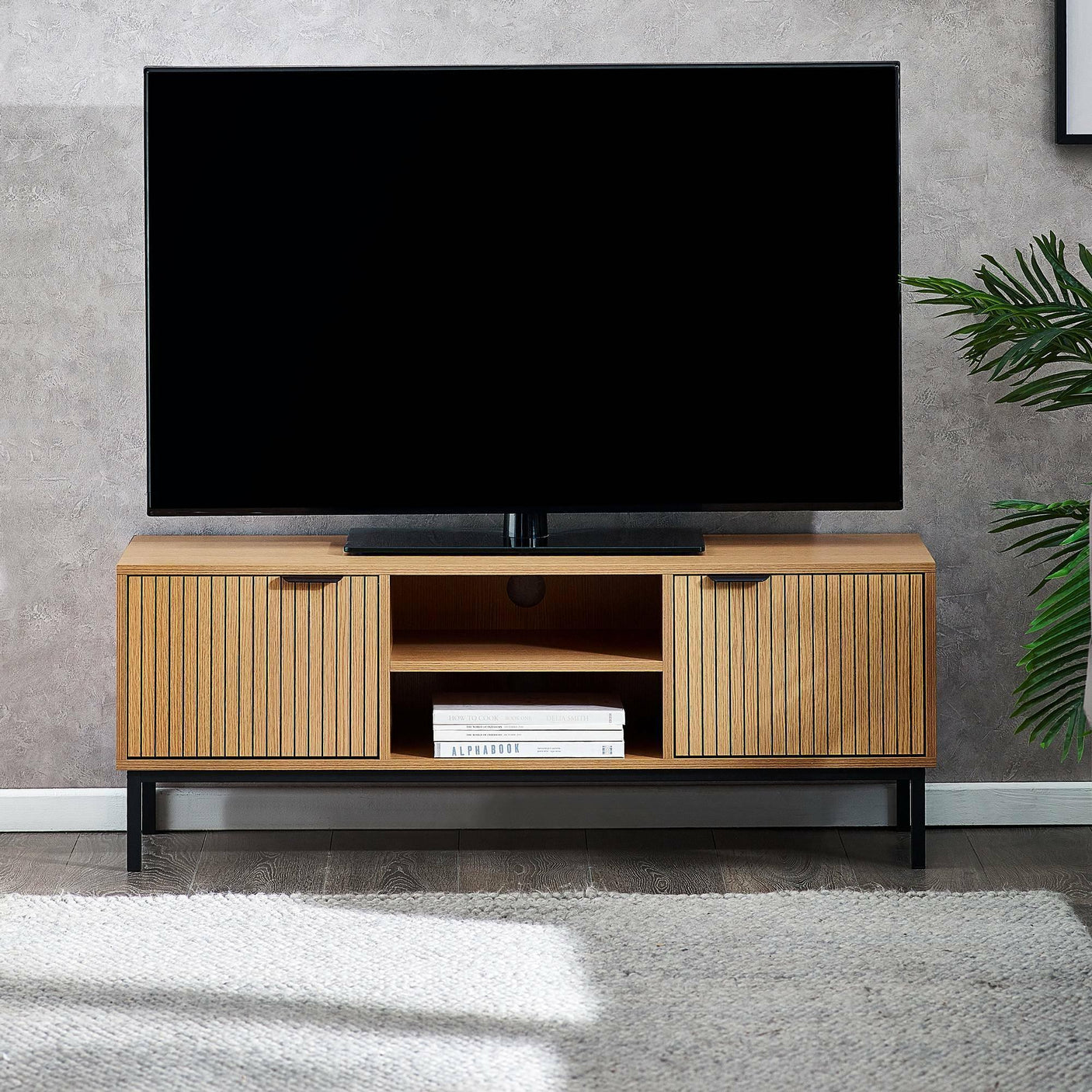 Wood media unit with slatted doors and open shelves in modern living room setting