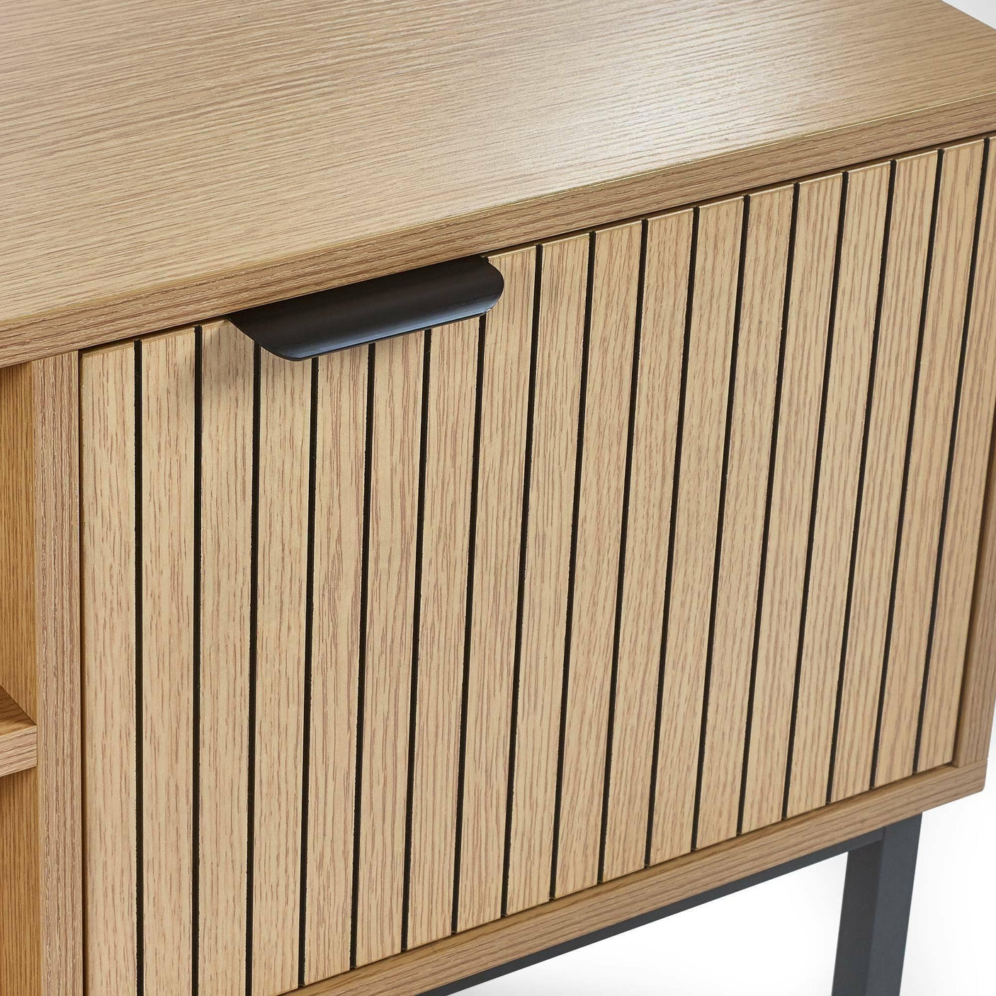 Oak wood cabinet with vertical slat door design and black metal handle on black legs