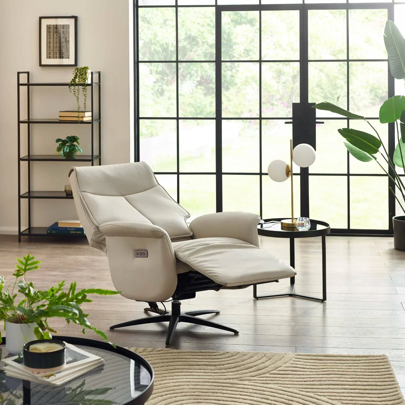 Sofia dual recliner chair in cream leather with footrest in modern living room setting