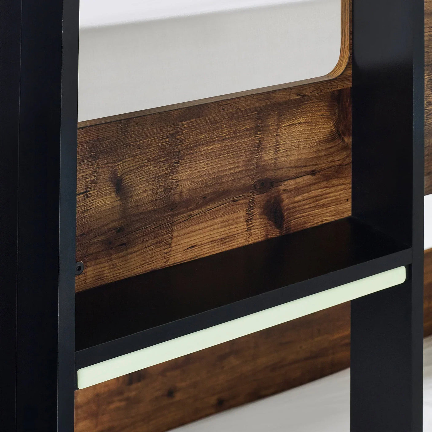 Bunk bed with rustic wood panel, black metal frame, and storage shelf detail