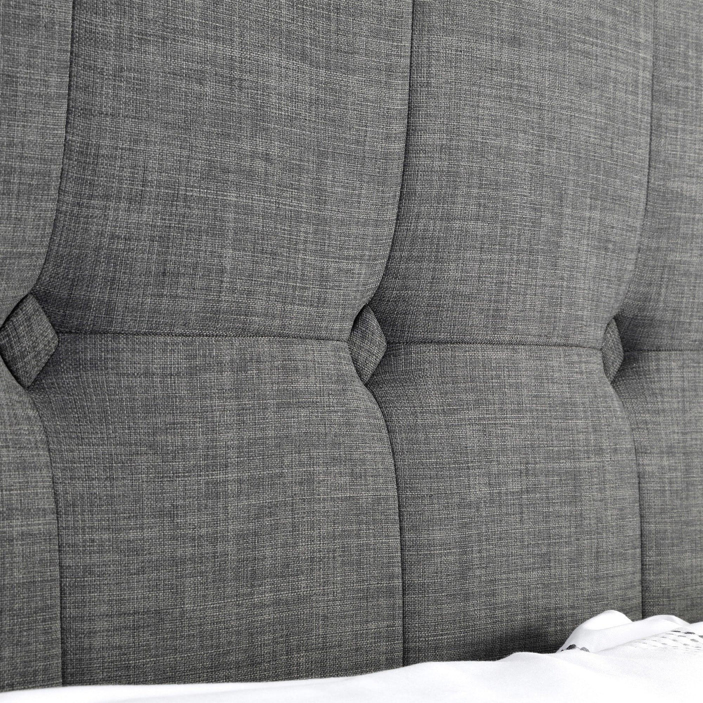 Close-up of slate linen bed headboard with stitched panel detail