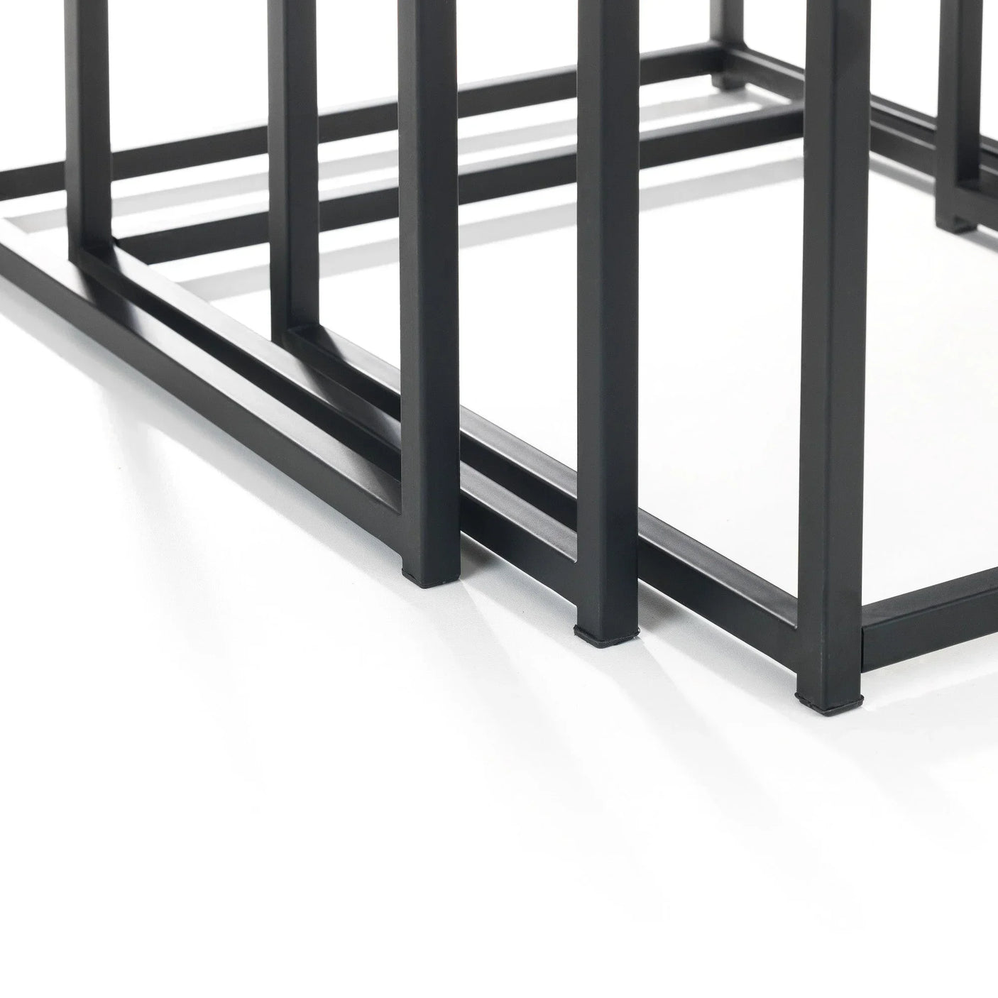 Black metal table frame with geometric legs on white background