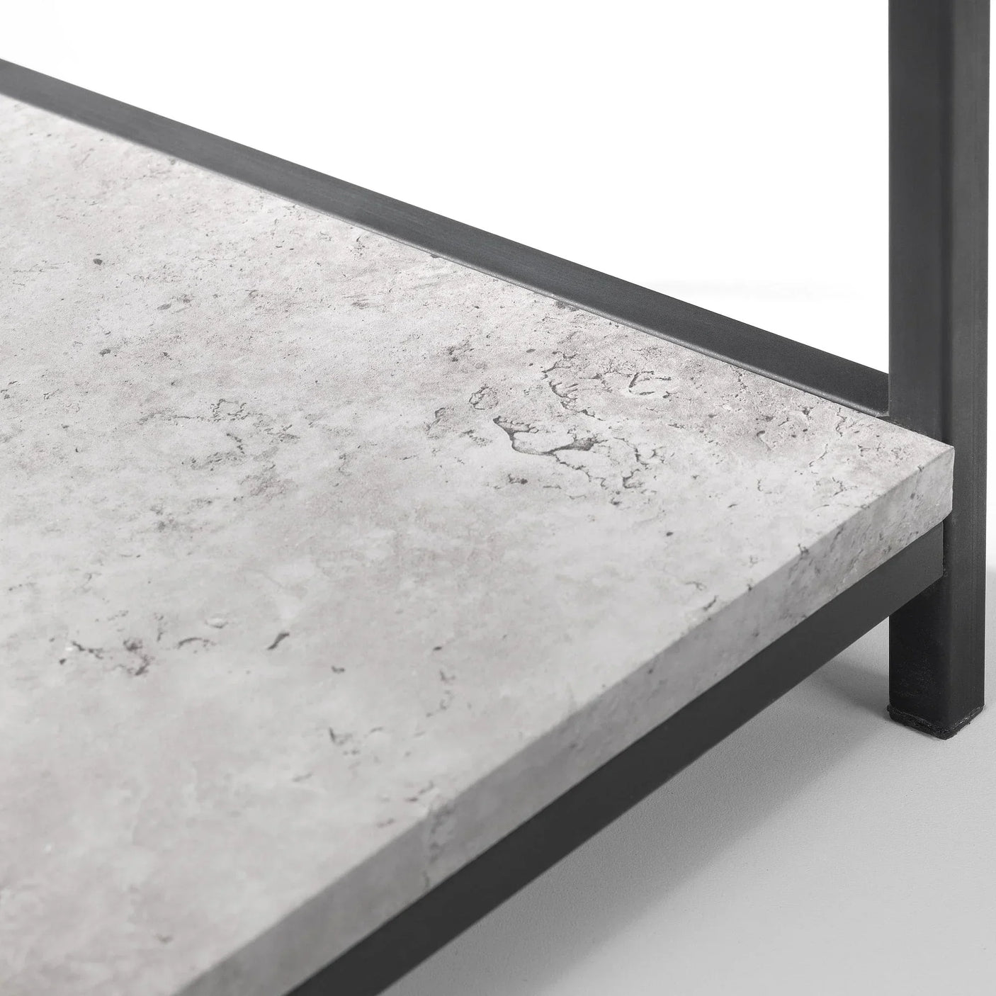 Concrete-effect shelf detail on black metal bookcase frame