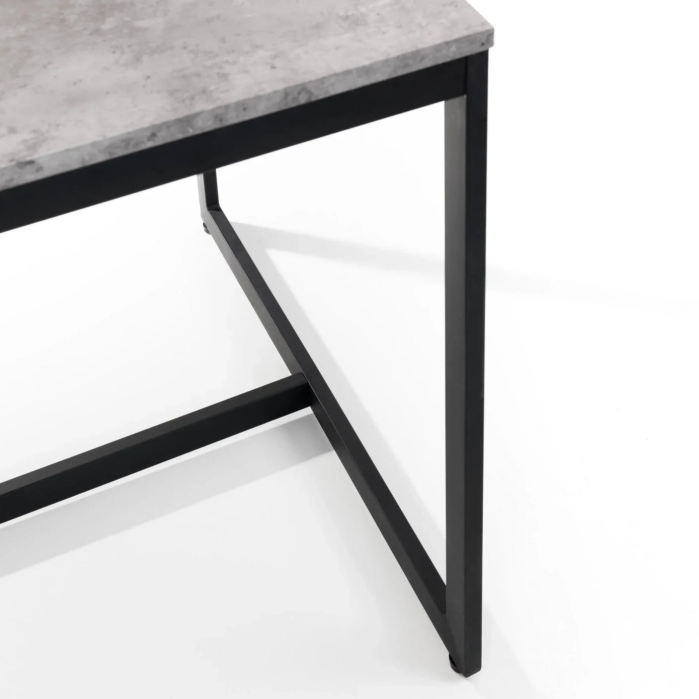 Grey stone effect dining table top with black metal frame close-up