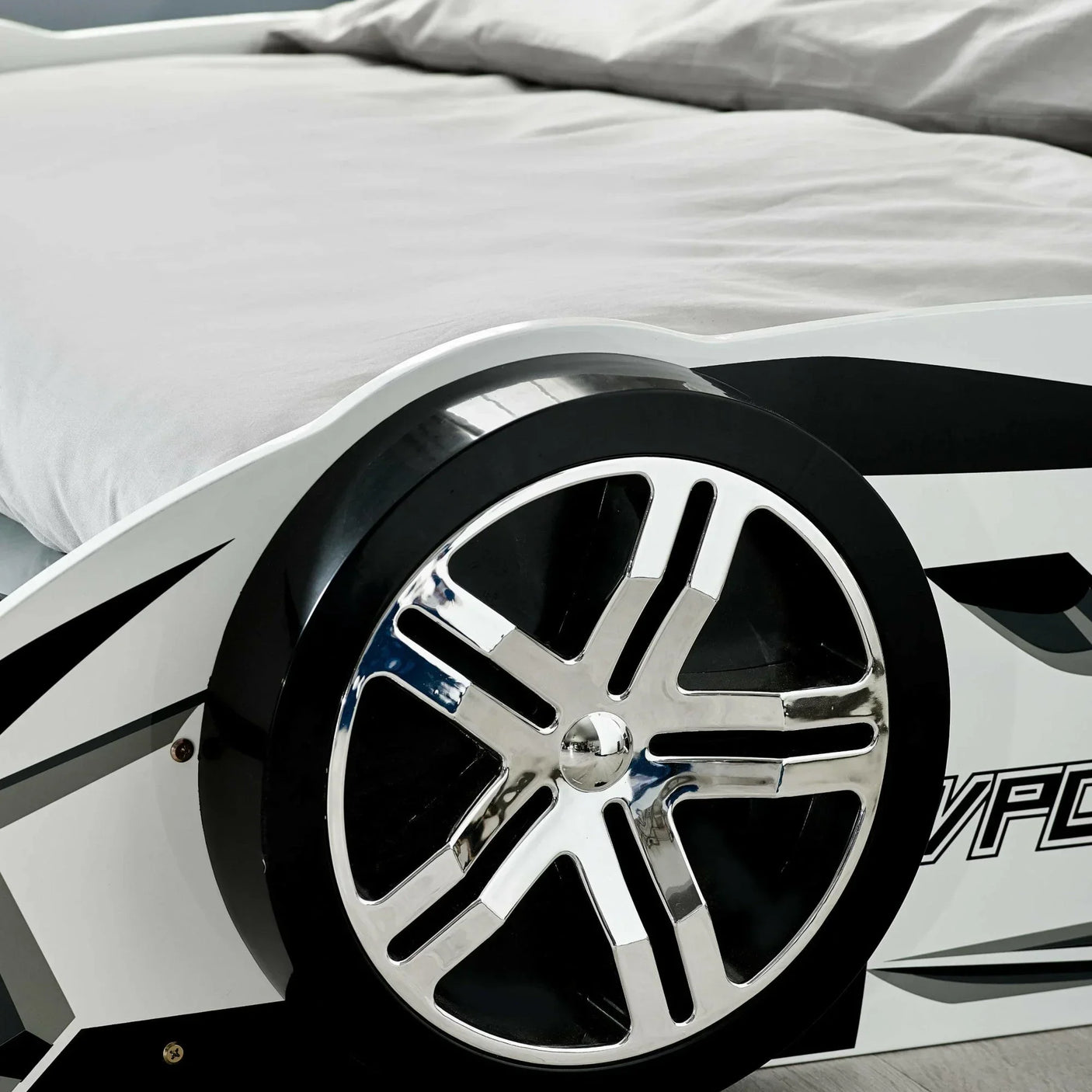 Car bed with black and chrome wheel detail and grey bedding