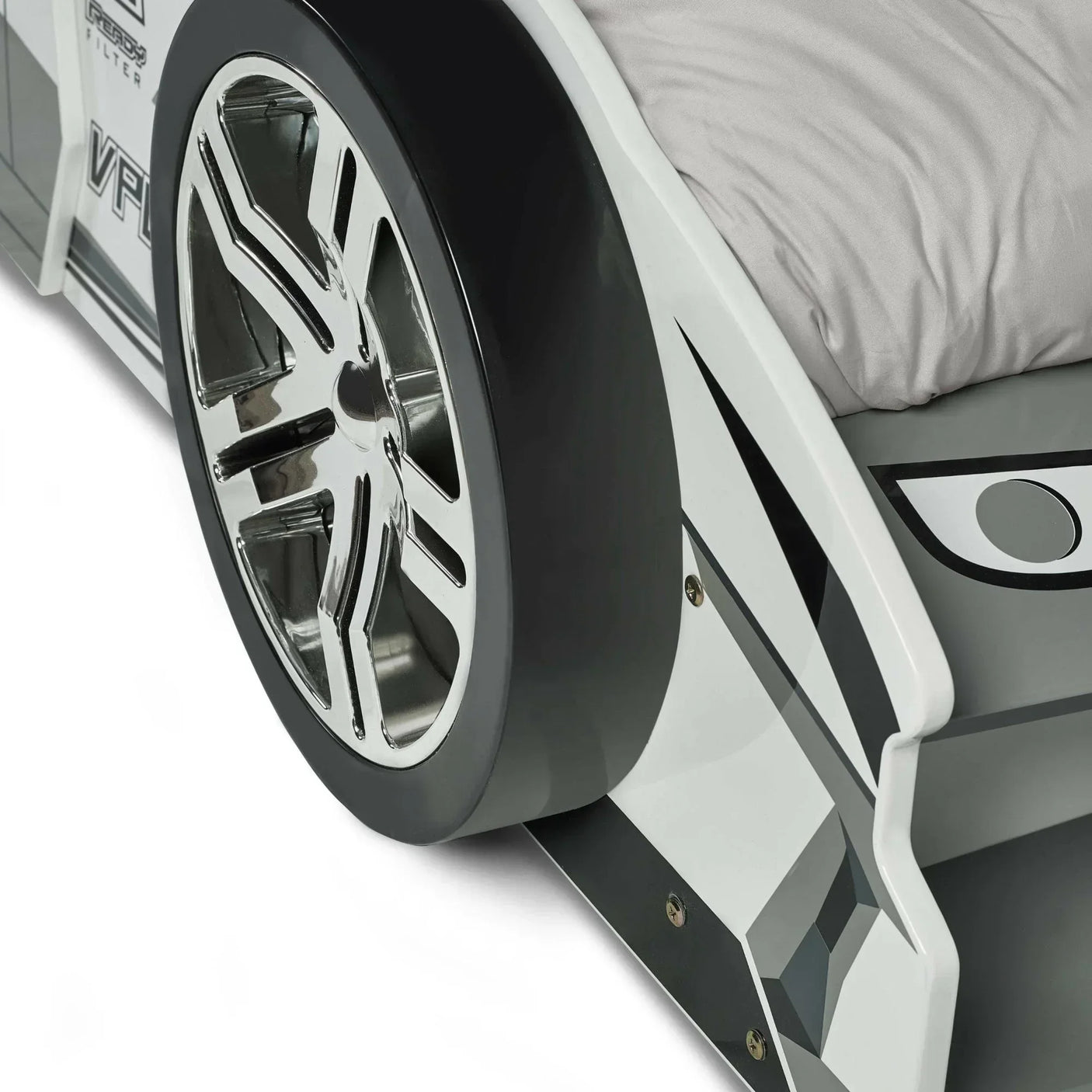 Silver car bed frame close-up showing chrome wheel and grey bedding