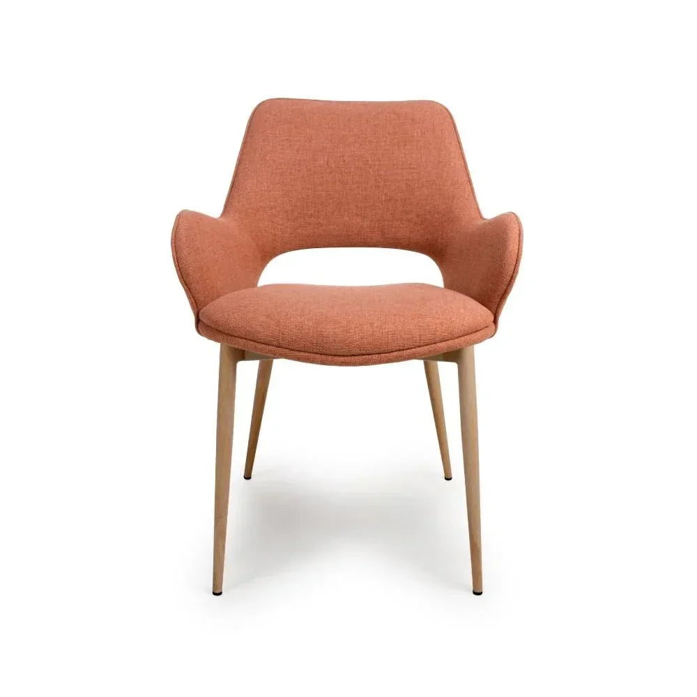 Modern dining chair with orange upholstered seat and light wood legs, front view