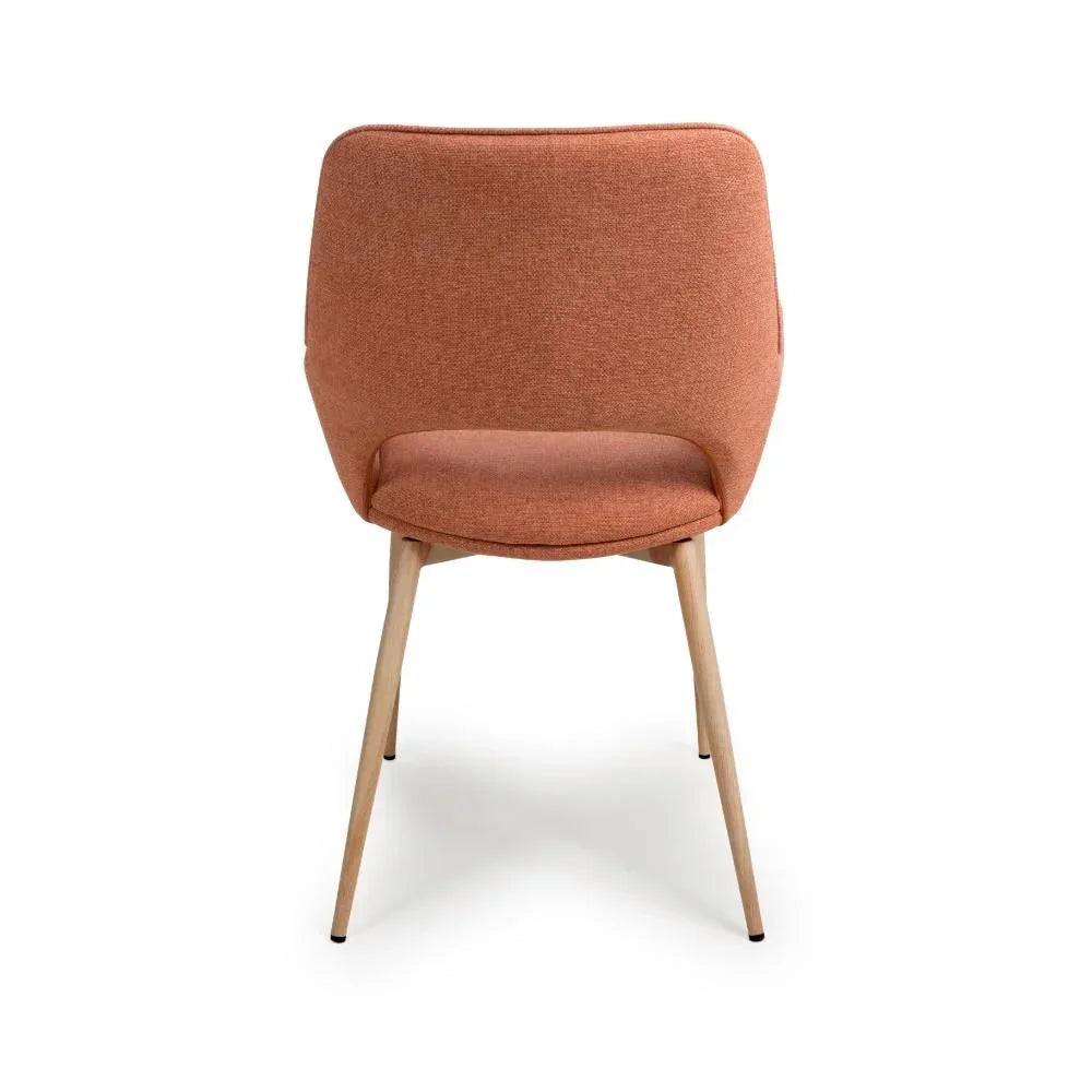 Rear view of orange fabric dining chair with padded seat and wooden legs