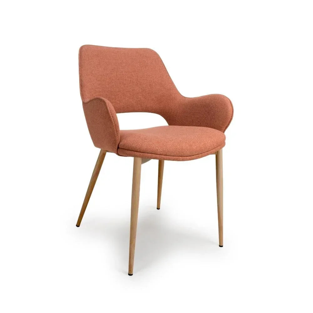 Orange fabric dining chair with curved arms and wooden legs on white background