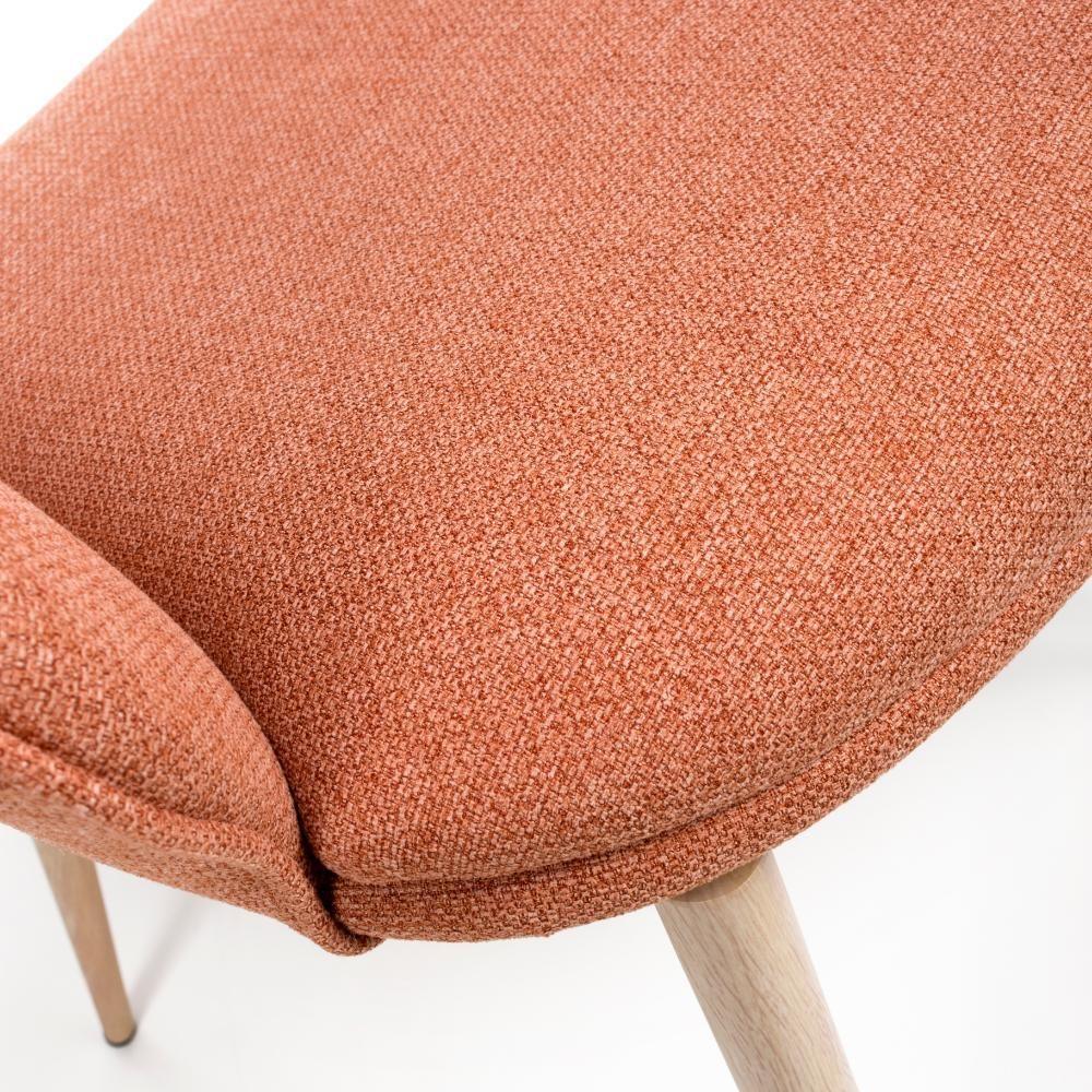 Close up of orange fabric dining chair seat with wooden legs