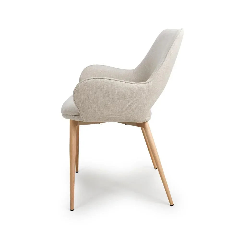 Light beige upholstered dining chair with wooden legs, side view