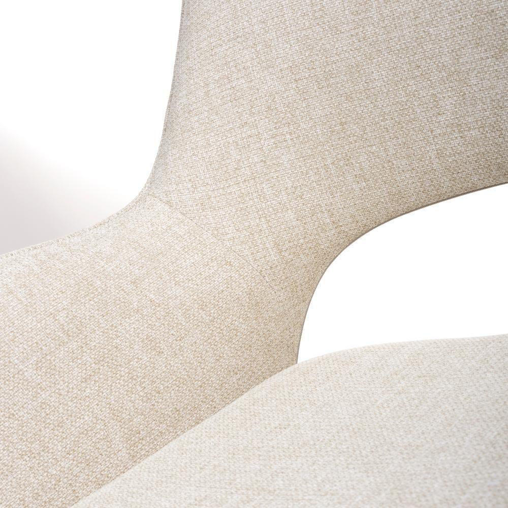 Closeup of beige fabric dining chair with curved back and seat detail