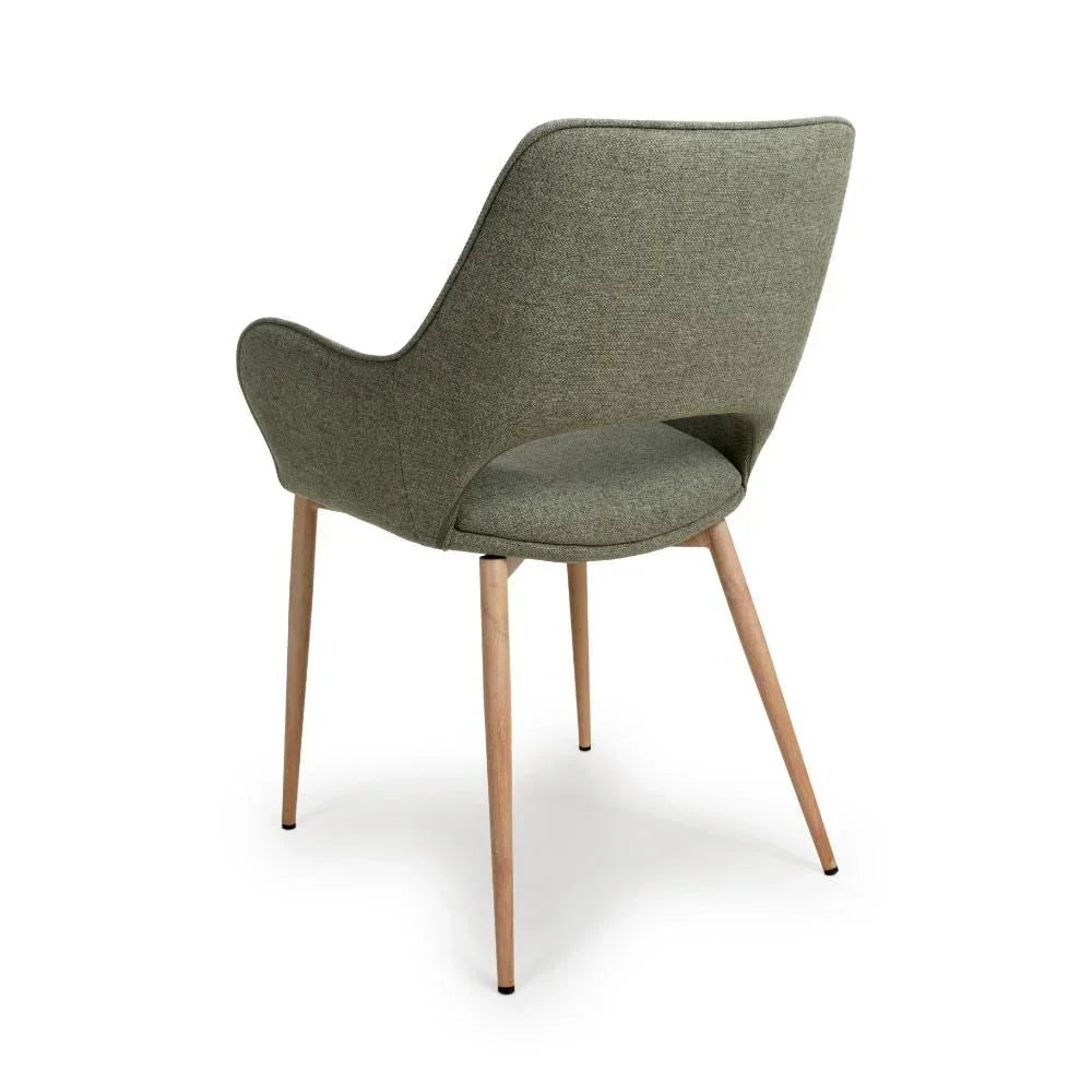 Green upholstered dining chair with curved back and light wooden legs, rear angle view