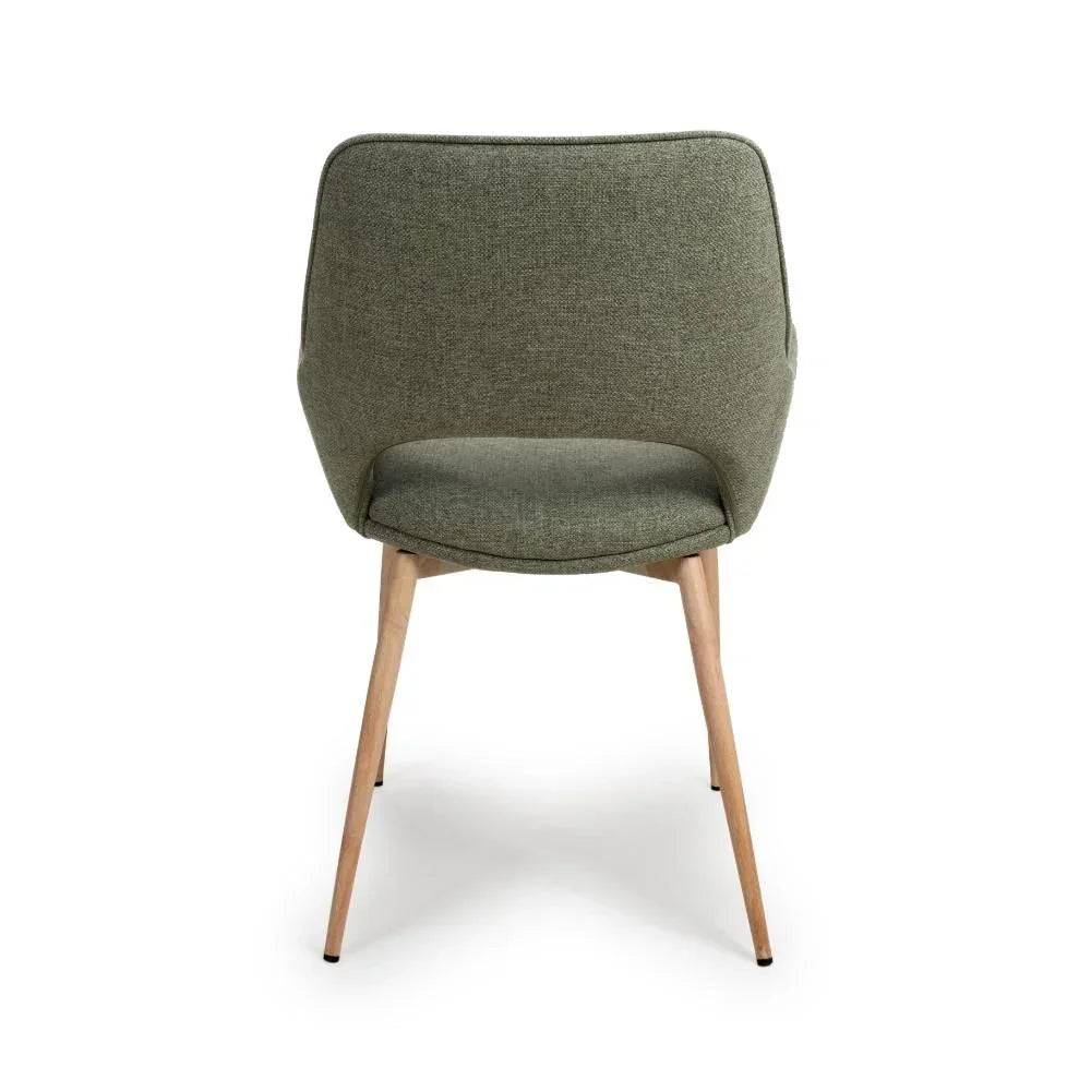 Rear view of green fabric dining chair with curved back and wooden legs