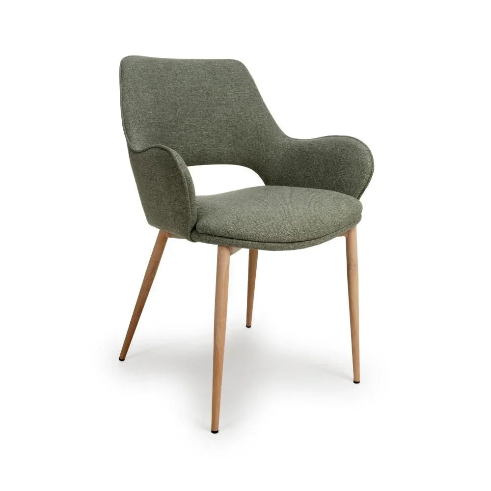 Green fabric dining chair with curved backrest and wooden legs, angled front view