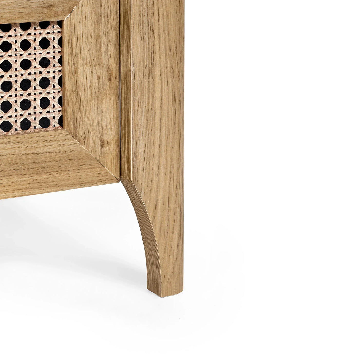 Corner detail of rattan effect drawer chest with natural wood finish and cane panel
