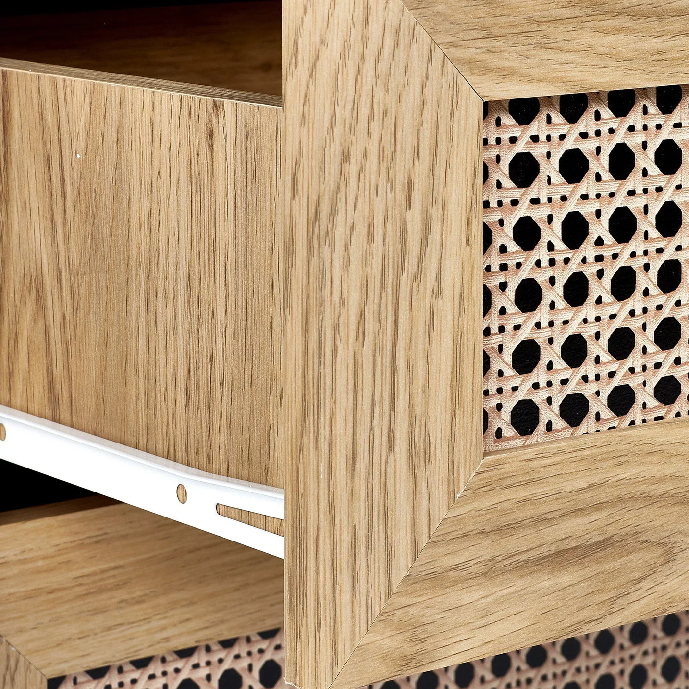 Close-up of rattan effect chest drawer front with natural wood grain frame