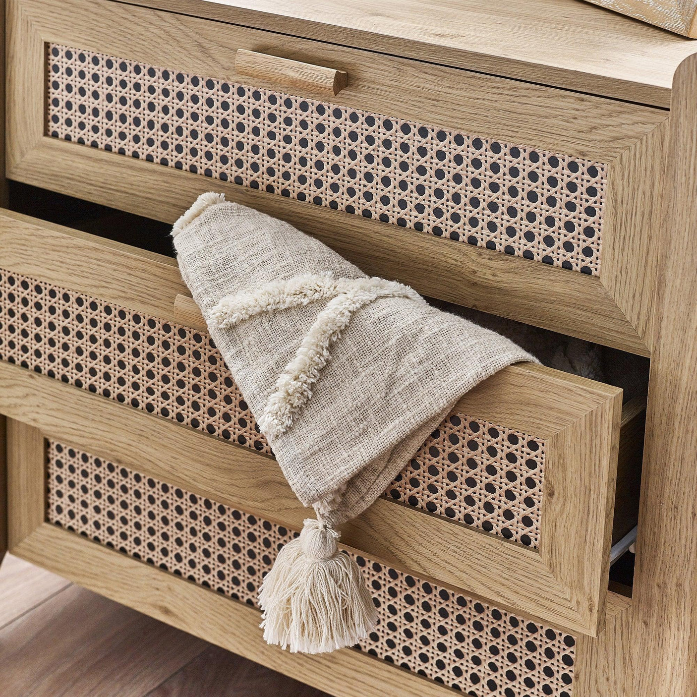 Sydney rattan effect 3 drawer chest with woven front detail and neutral tassel throw