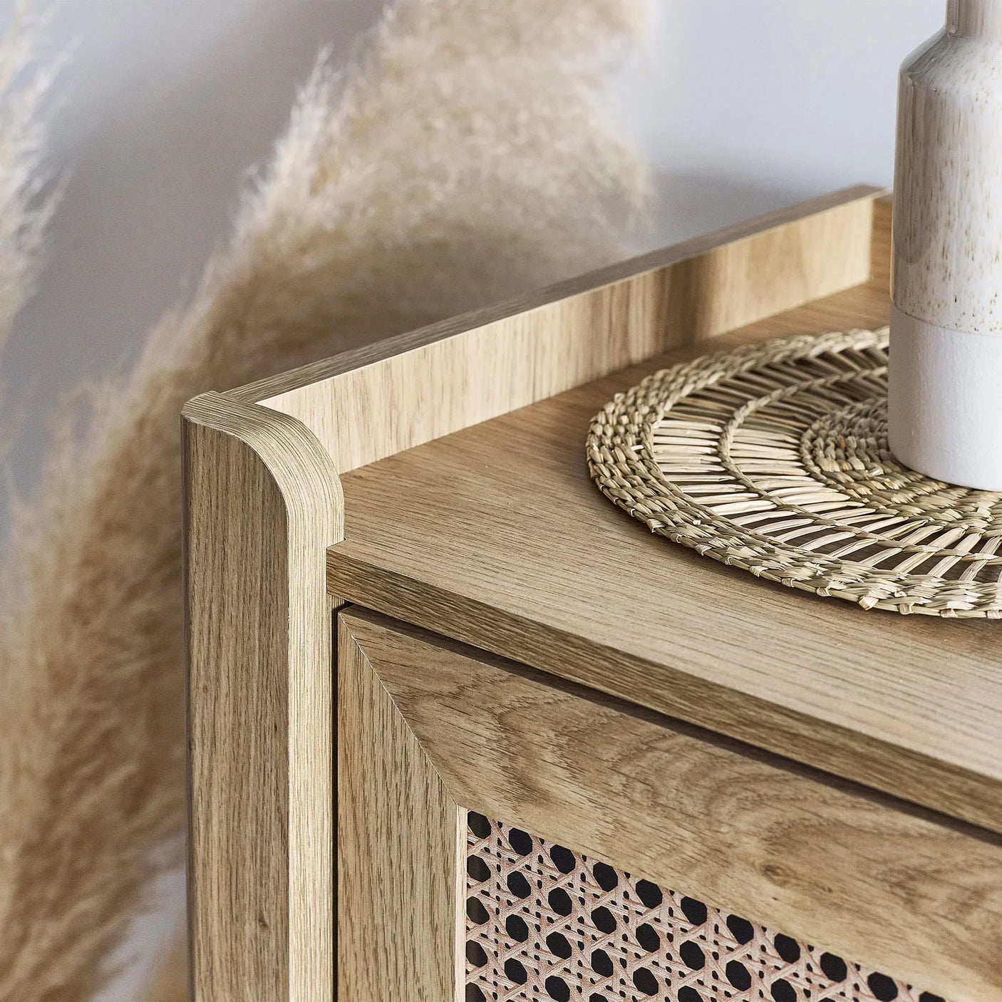 Closeup of Sydney rattan effect 3 drawer chest corner with woven drawer and decorative tray