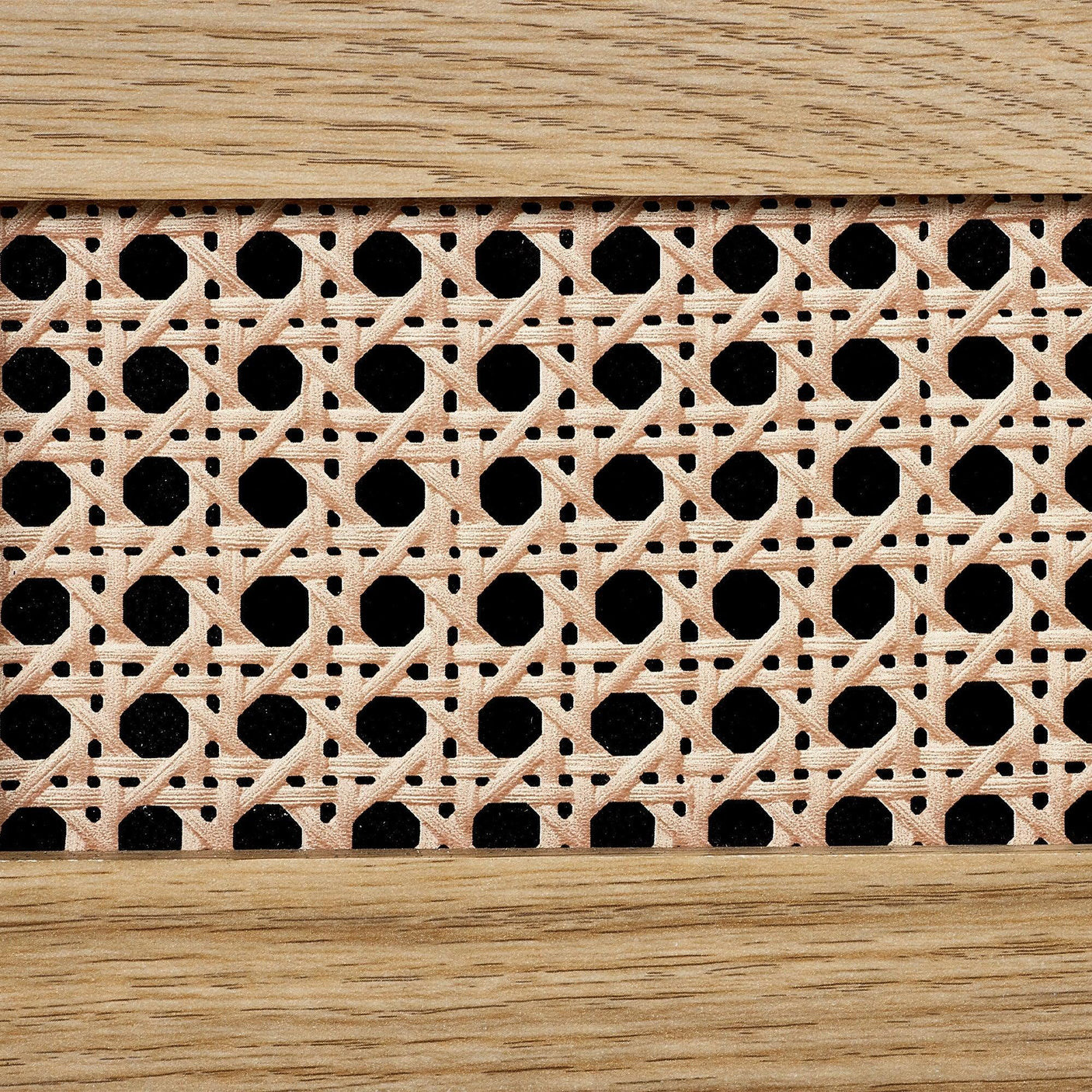 Close-up of rattan effect detail on three drawer chest with natural wood frame