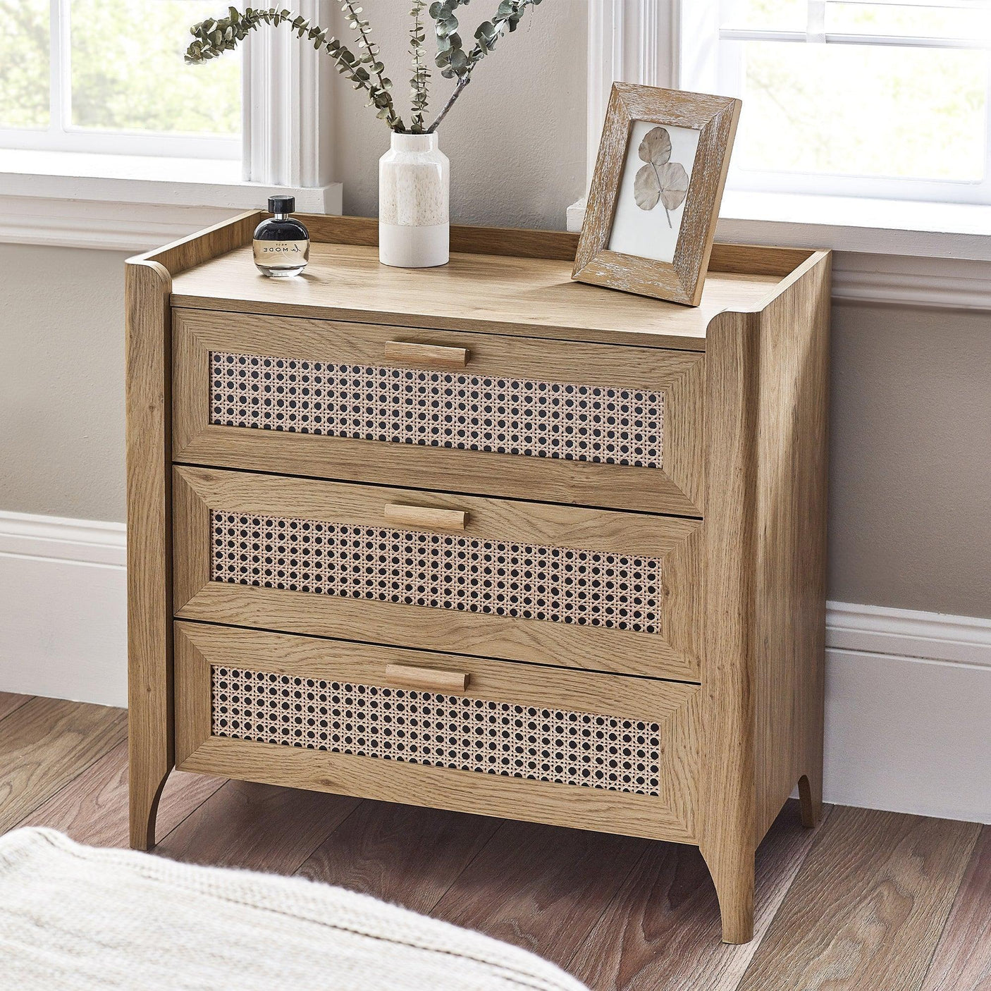 Sydney rattan effect 3 drawer chest with wooden frame in bright bedroom corner