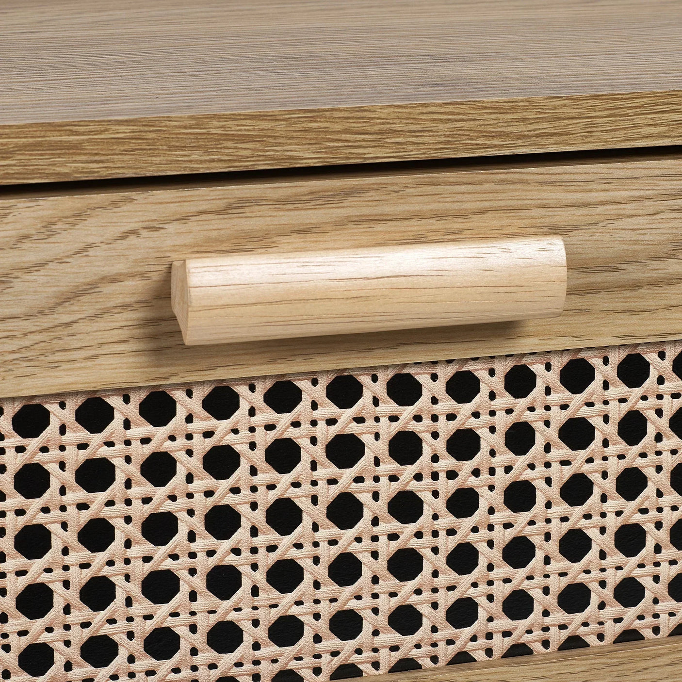 Close-up of rattan effect drawer front and wooden handle on wide chest of drawers