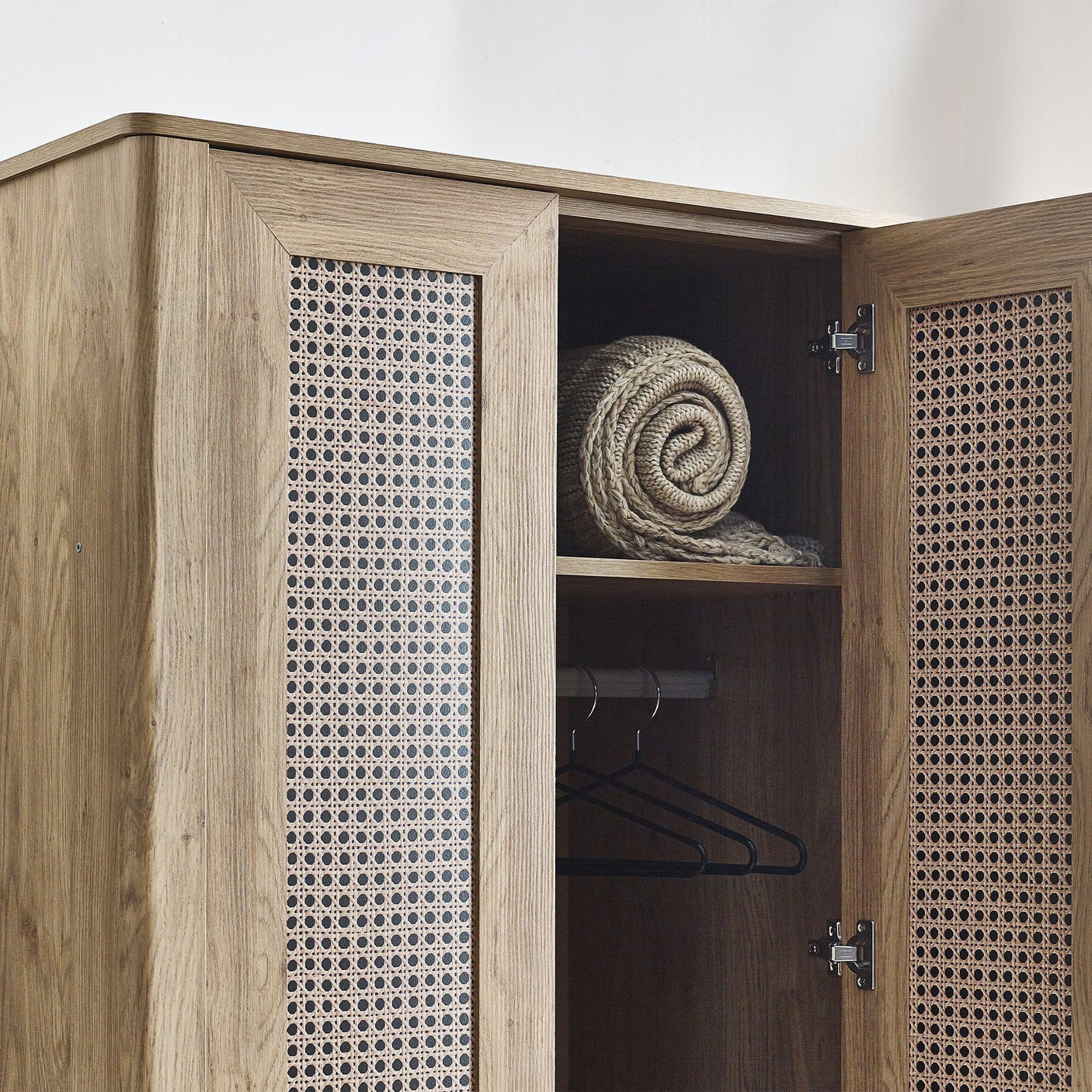 Sydney rattan effect wardrobe open to show shelf, rail and cane panel doors