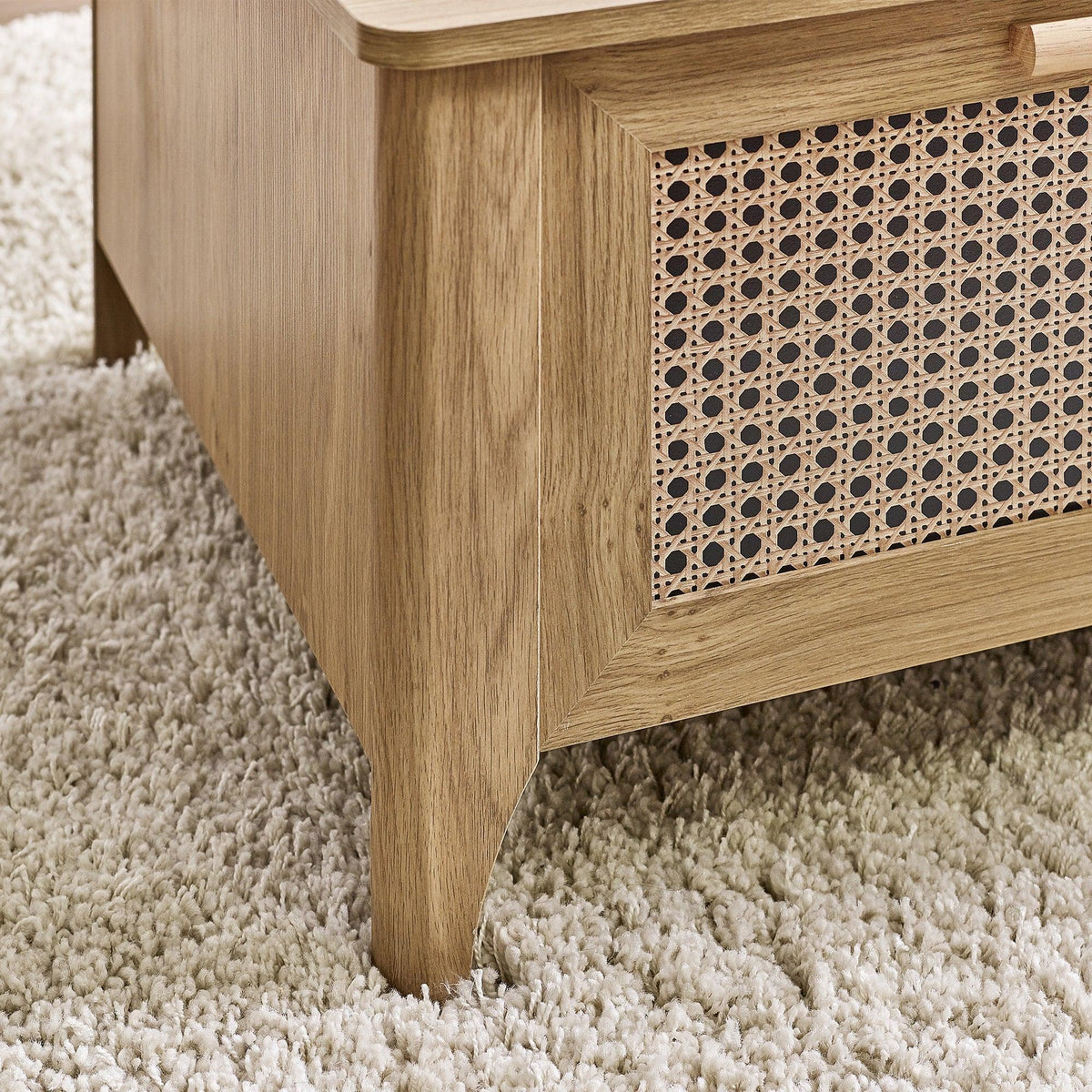 Sydney rattan effect coffee table corner showing wood finish and woven panel detail