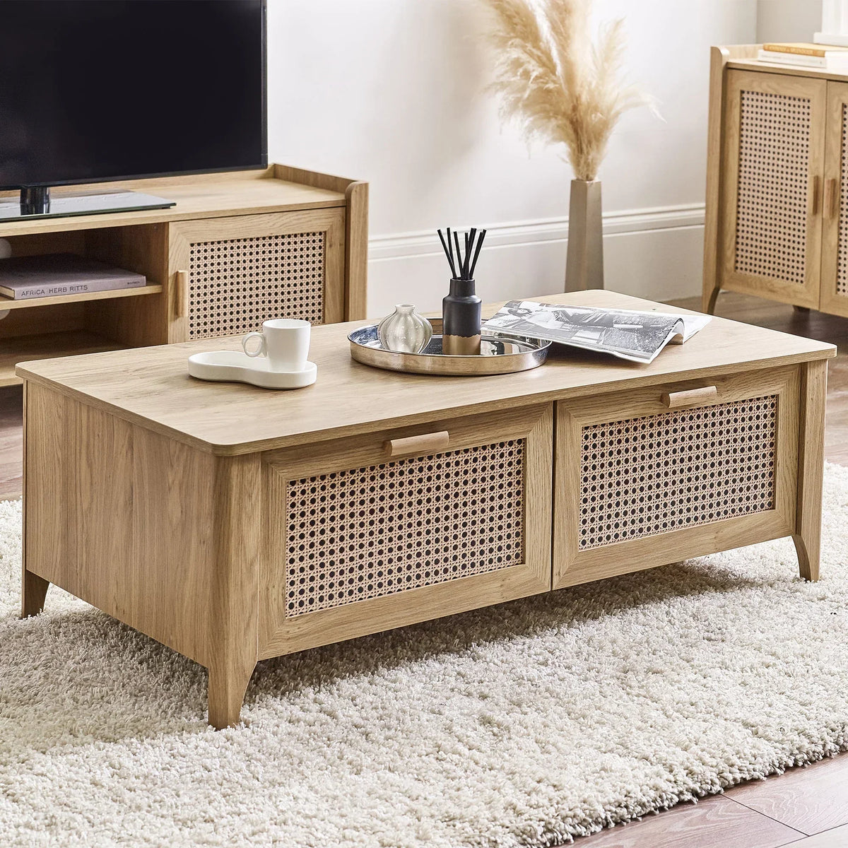 Rattan effect coffee table with storage on cream rug in modern living room