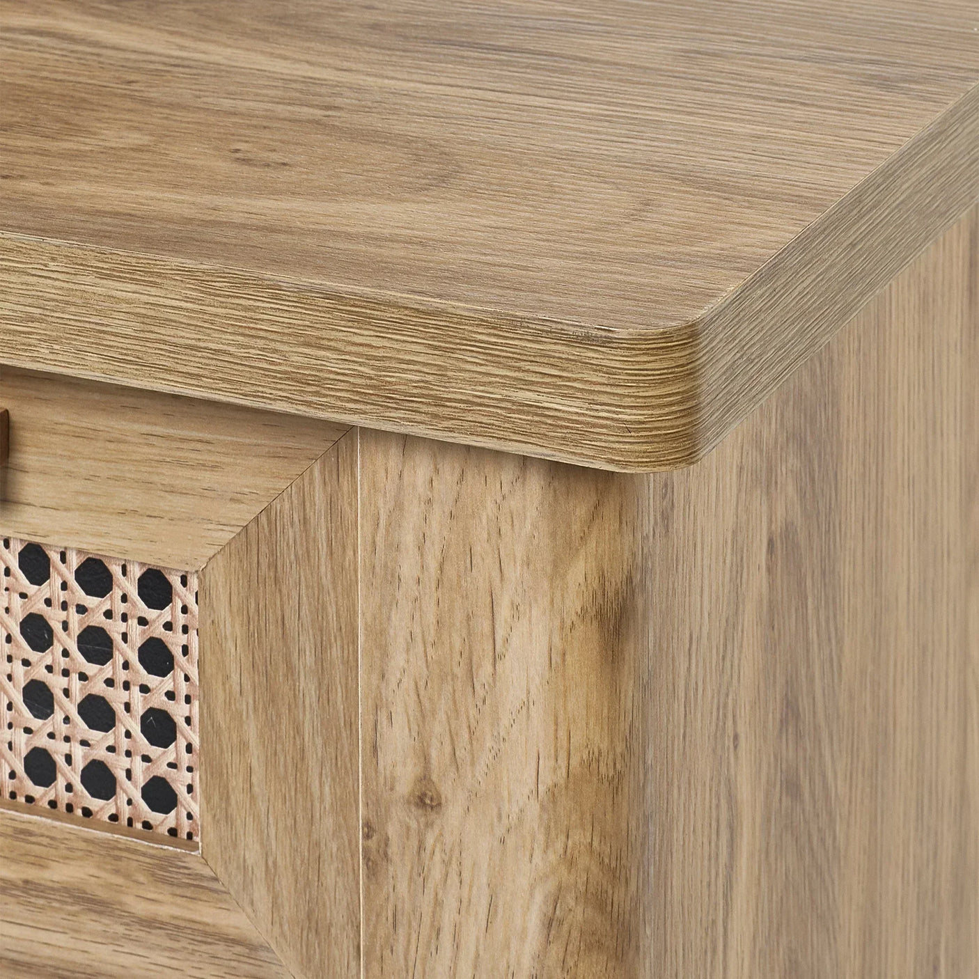 Close-up of Sydney rattan effect desk corner with wood grain finish and woven panel detail