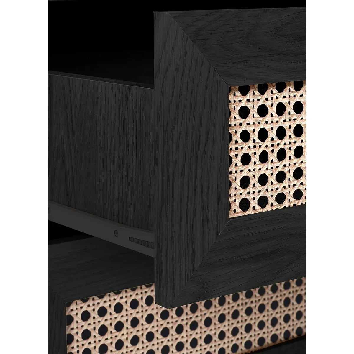 Close-up of black wood drawer with rattan front panel, modern furniture detail