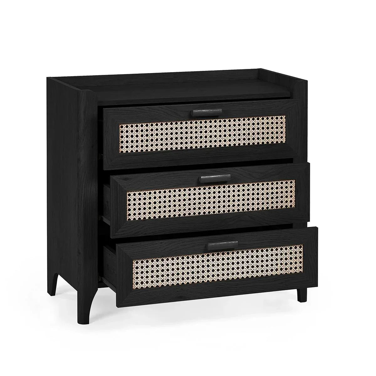 Black wooden chest of drawers with cane rattan front panels and metal handles, angled view