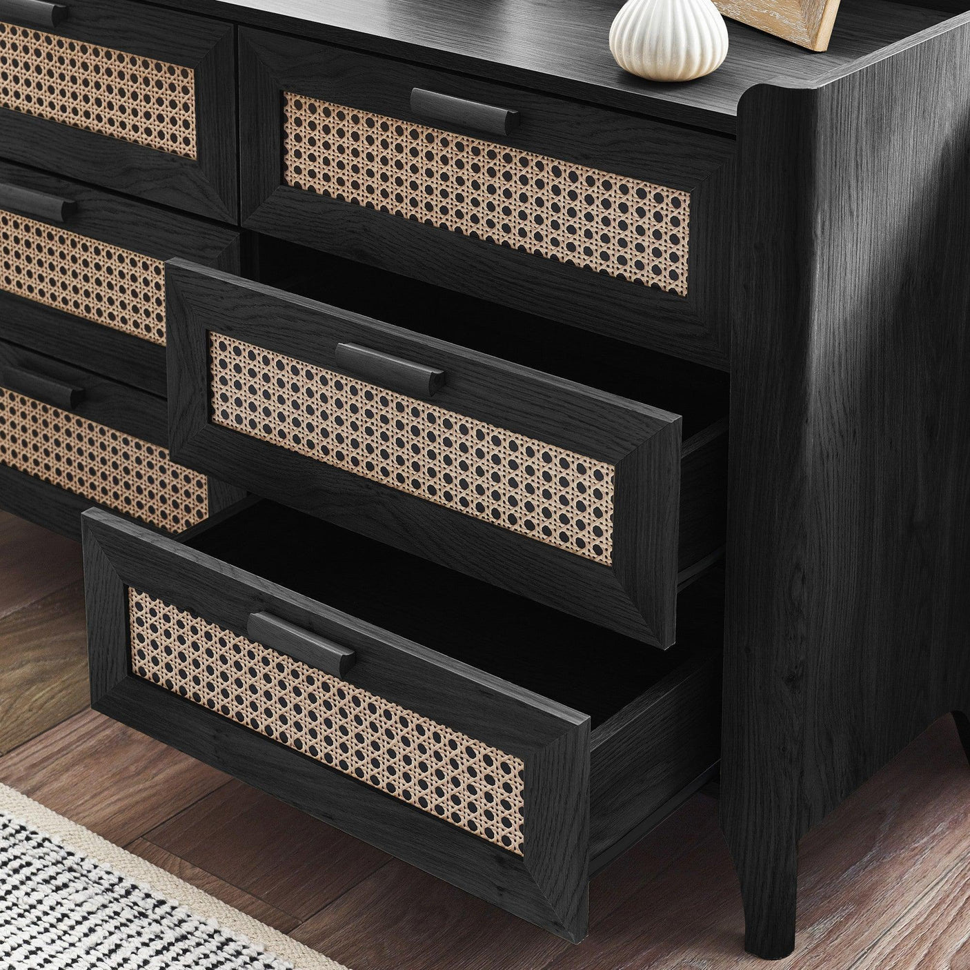 Black ash rattan effect chest of drawers with two open drawers, showing woven detail