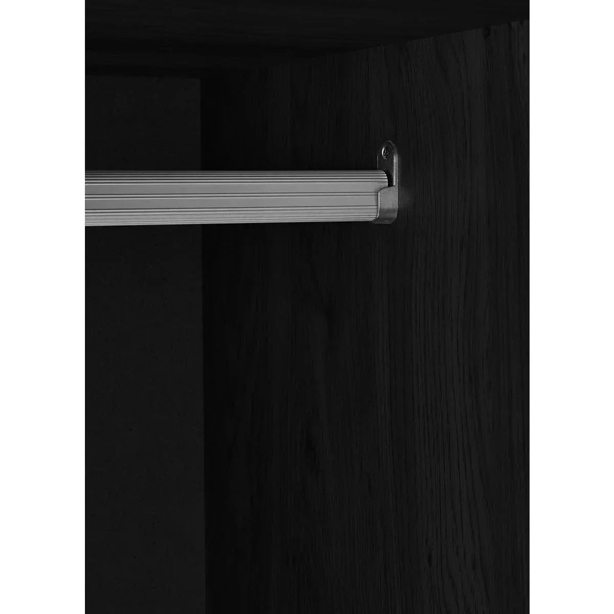 Metal wardrobe rail mounted inside dark wood closet interior