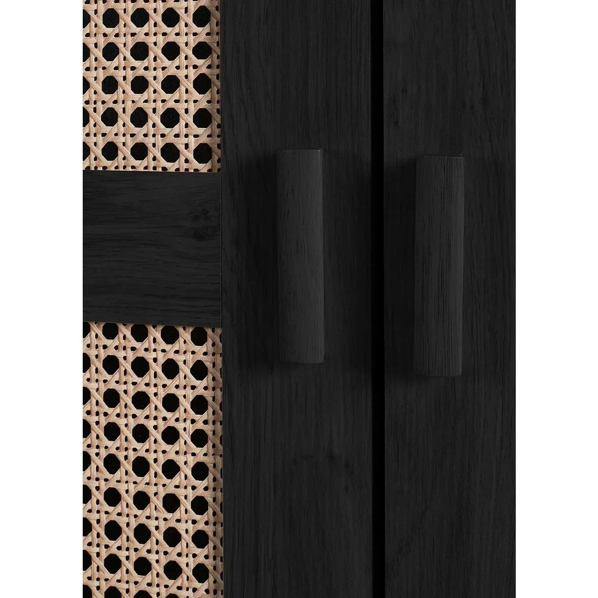close up of black wood cabinet doors with cane panel and round handles