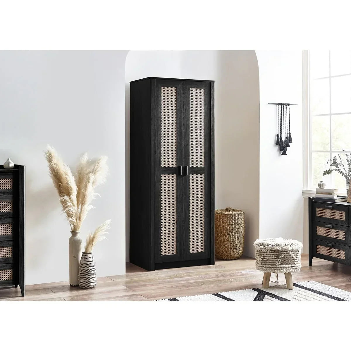 Black rattan wardrobe with double doors in modern bedroom setting