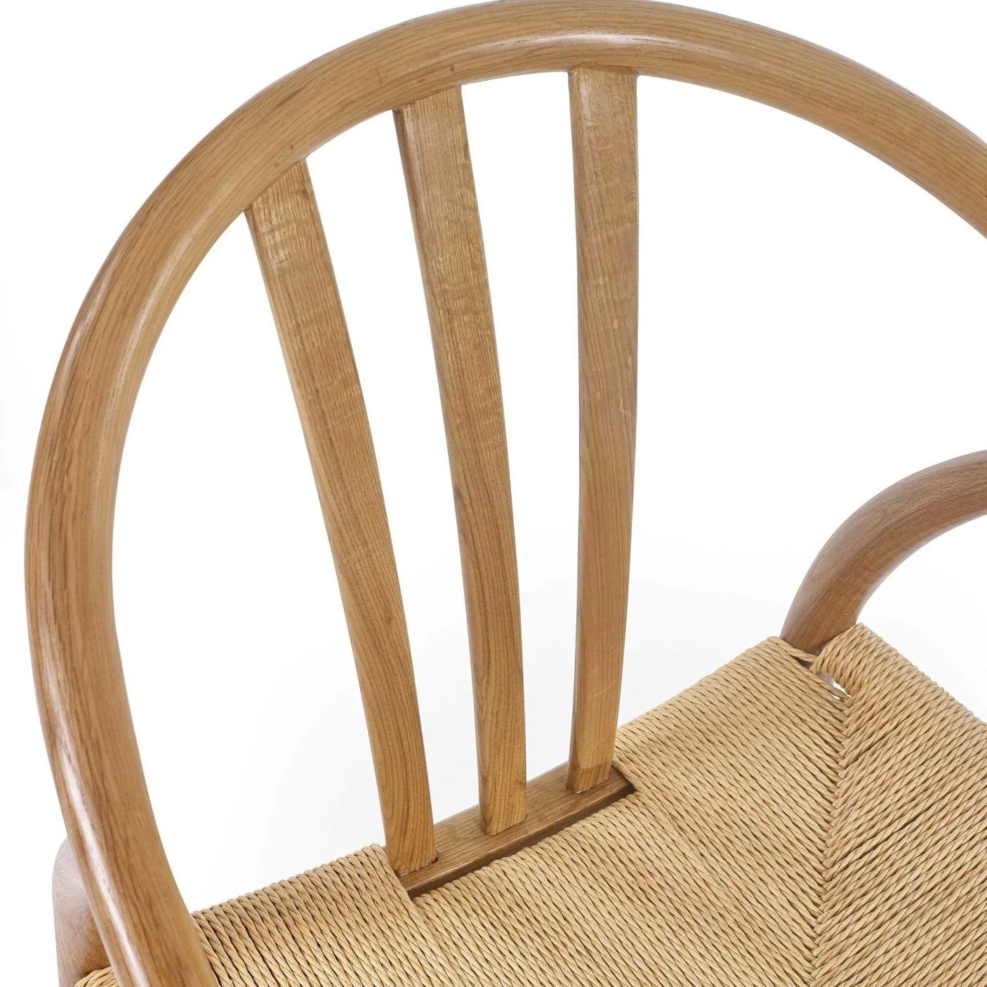 Oak dining chair with curved backrest and woven seat, close-up on woodgrain and texture