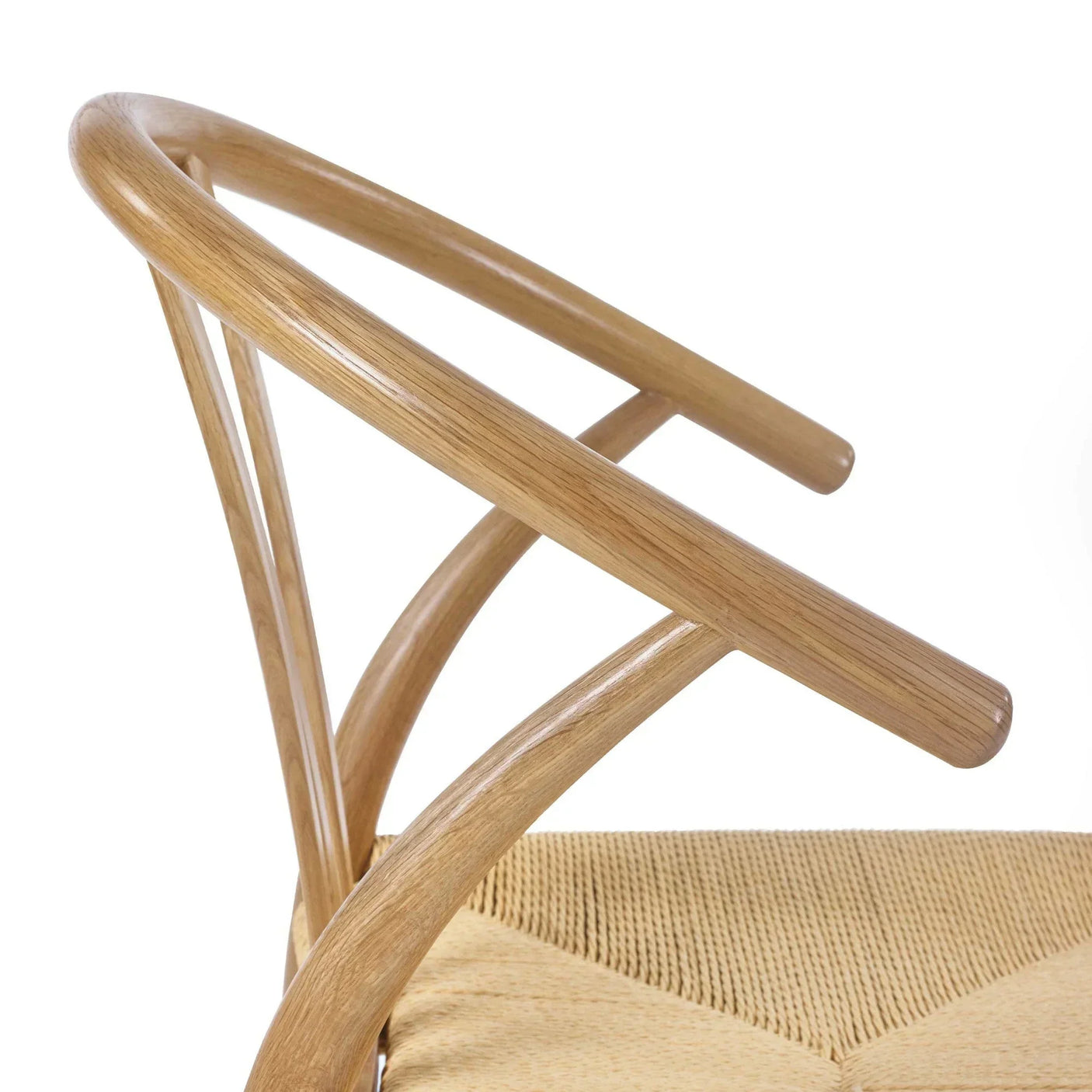 Curved oak dining chair frame with woven seat detail, side angle view