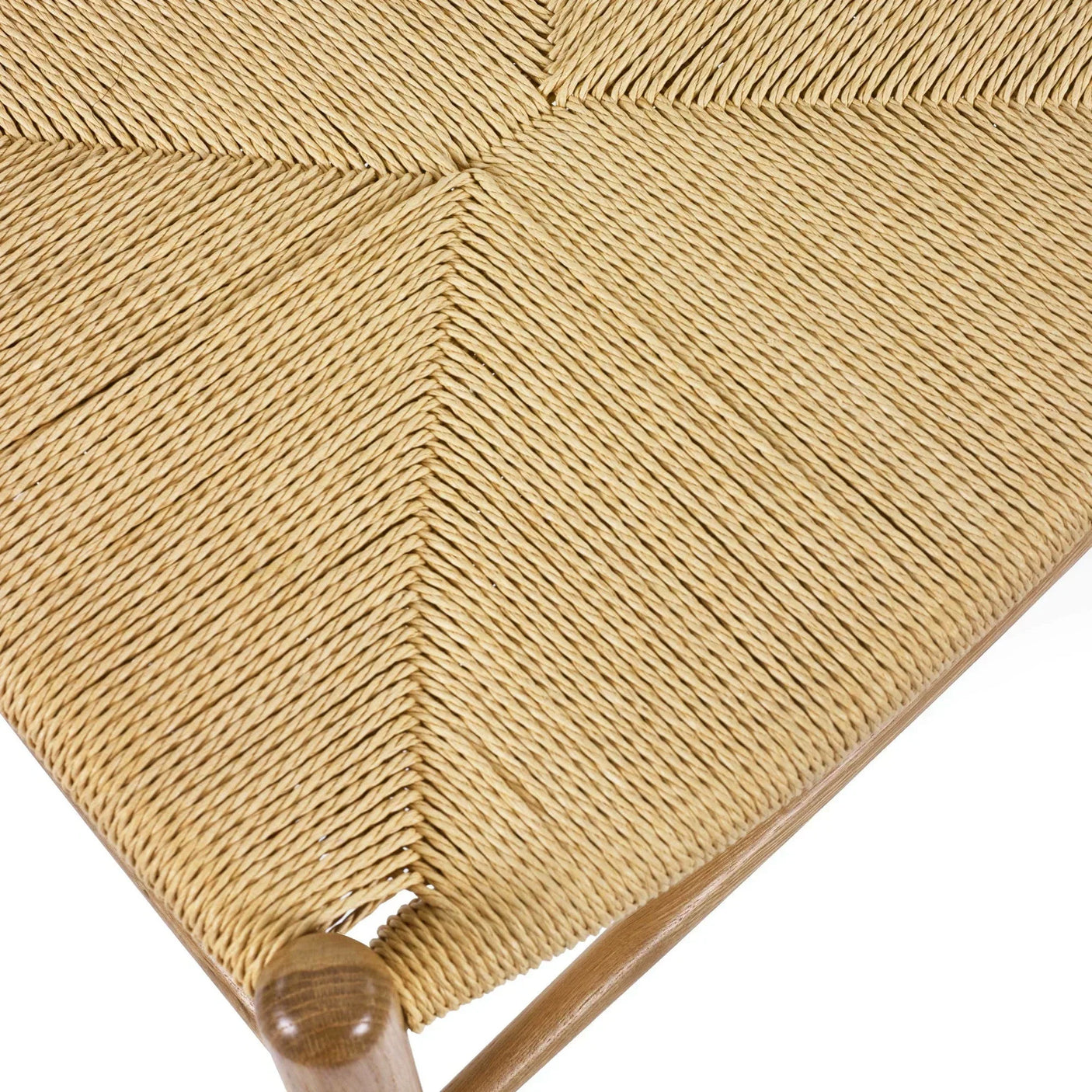 Closeup of woven natural cord dining chair seat with wooden frame corner detail