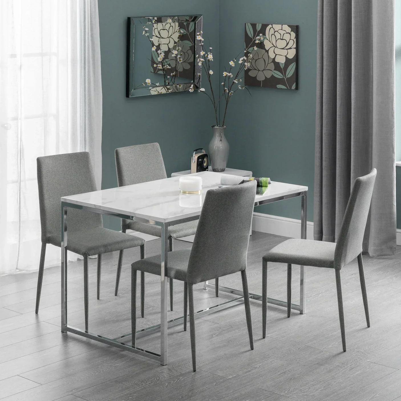 Scala dining table with four grey Jazz chairs in modern dining room with wall art