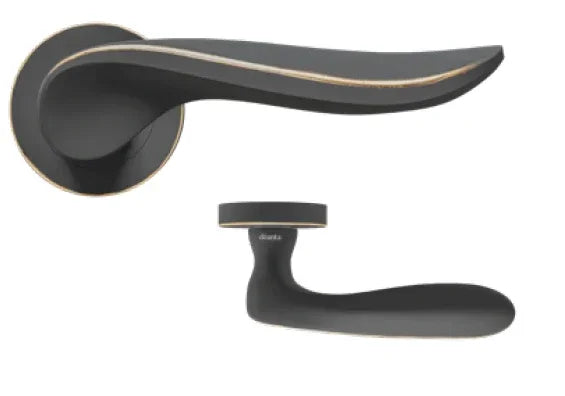 Matte black door handle with gold trim and round rose detail, shown from two angles
