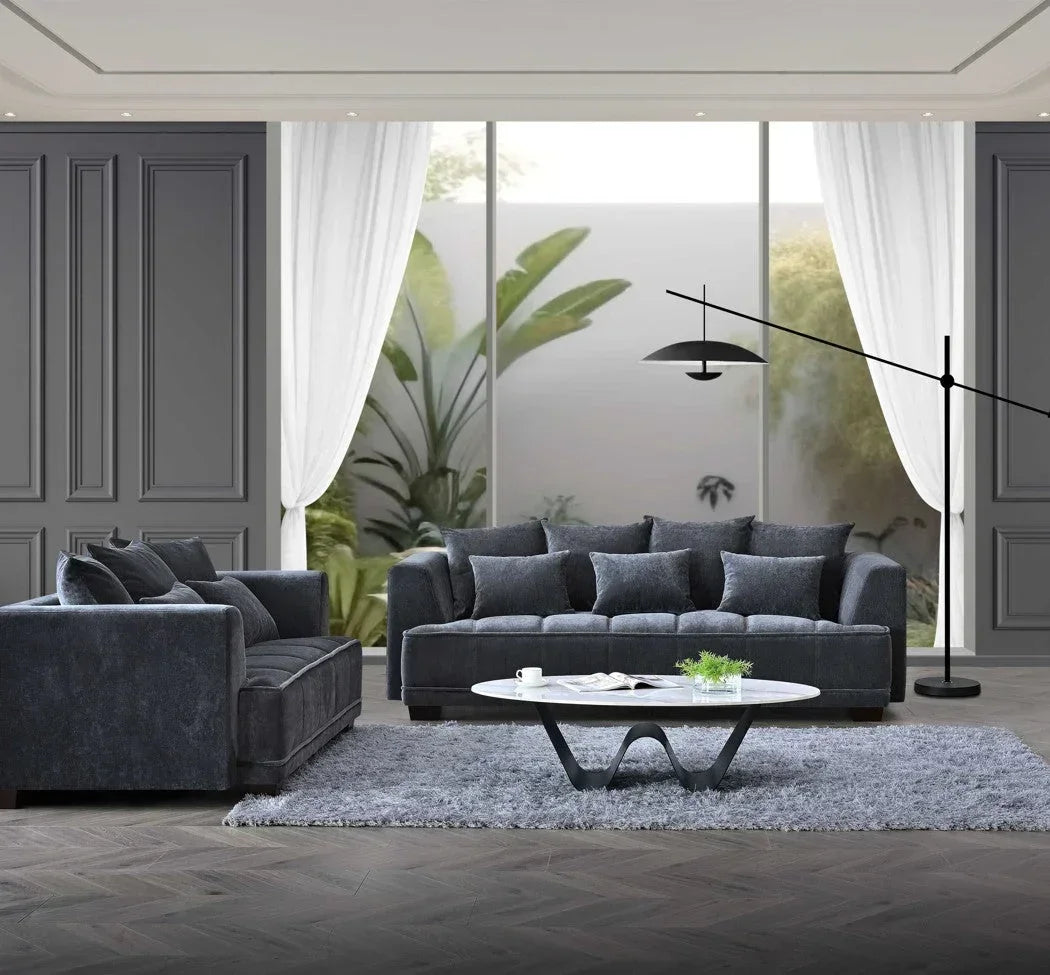 Dark grey velvet sofa set with matching cushions in modern living room, oval coffee table
