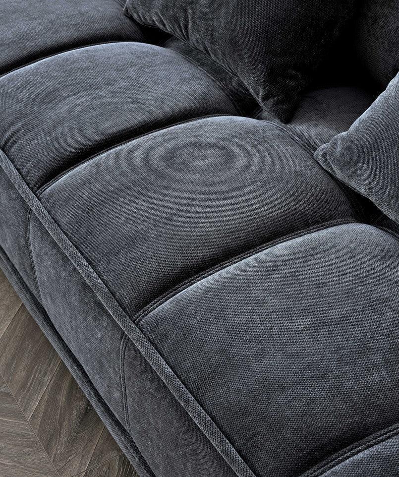 Dark grey fabric sofa seat closeup with plush cushions and textured upholstery