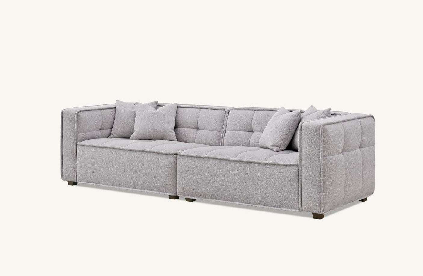 Light grey corner sofa with tufted upholstery and three matching cushions