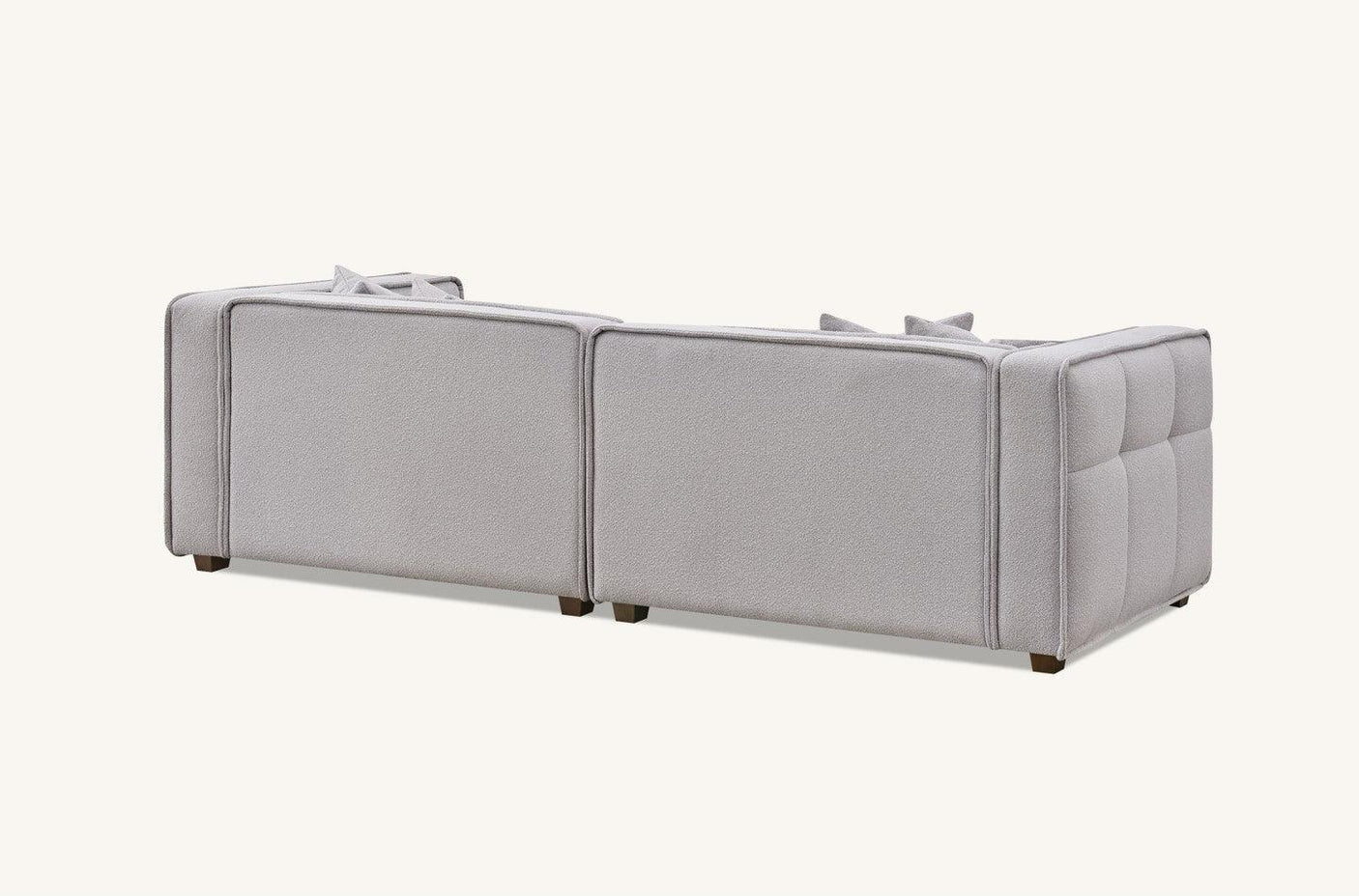 Rear view of light grey fabric sofa with clean lines and padded armrests