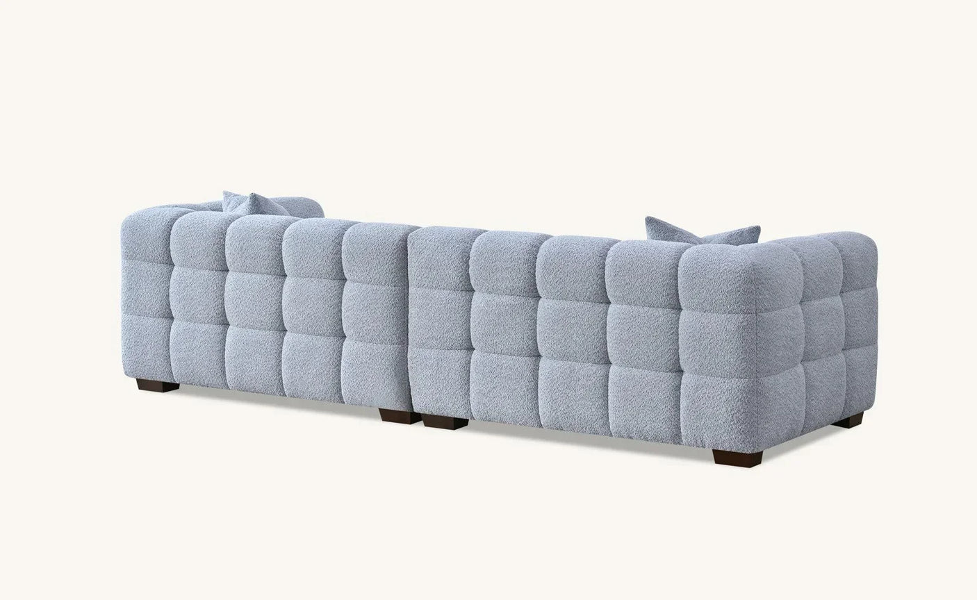 Light grey tufted fabric sofa with wooden legs, rear angle view