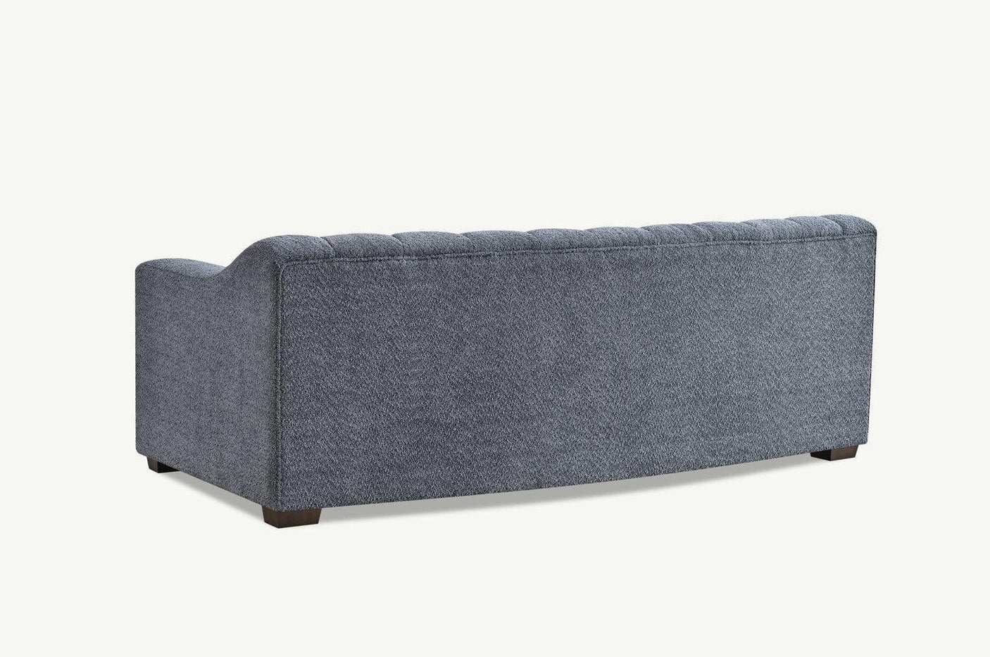 Rear view of grey fabric sofa with tufted backrest and wooden legs